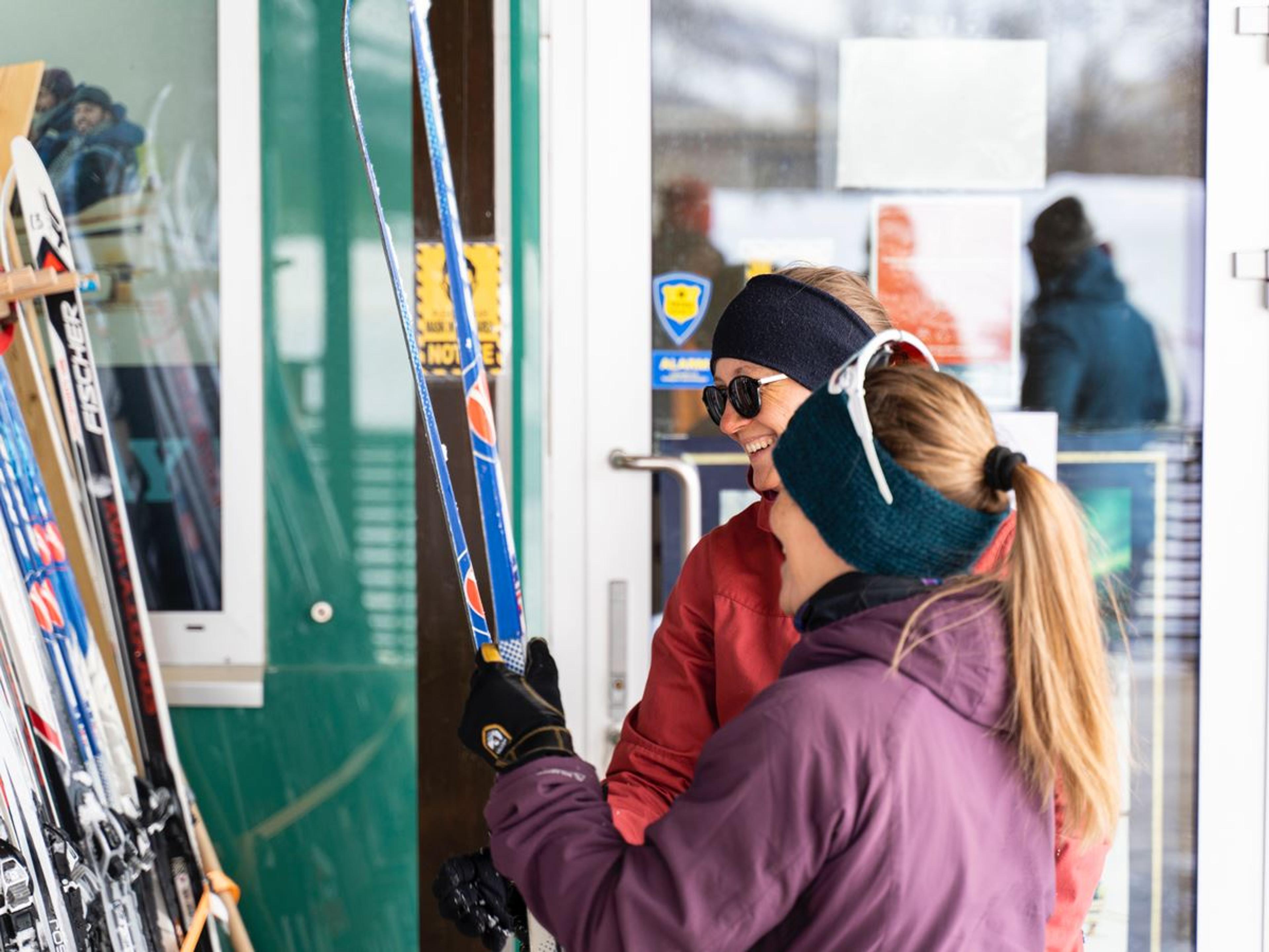 People holding skis.