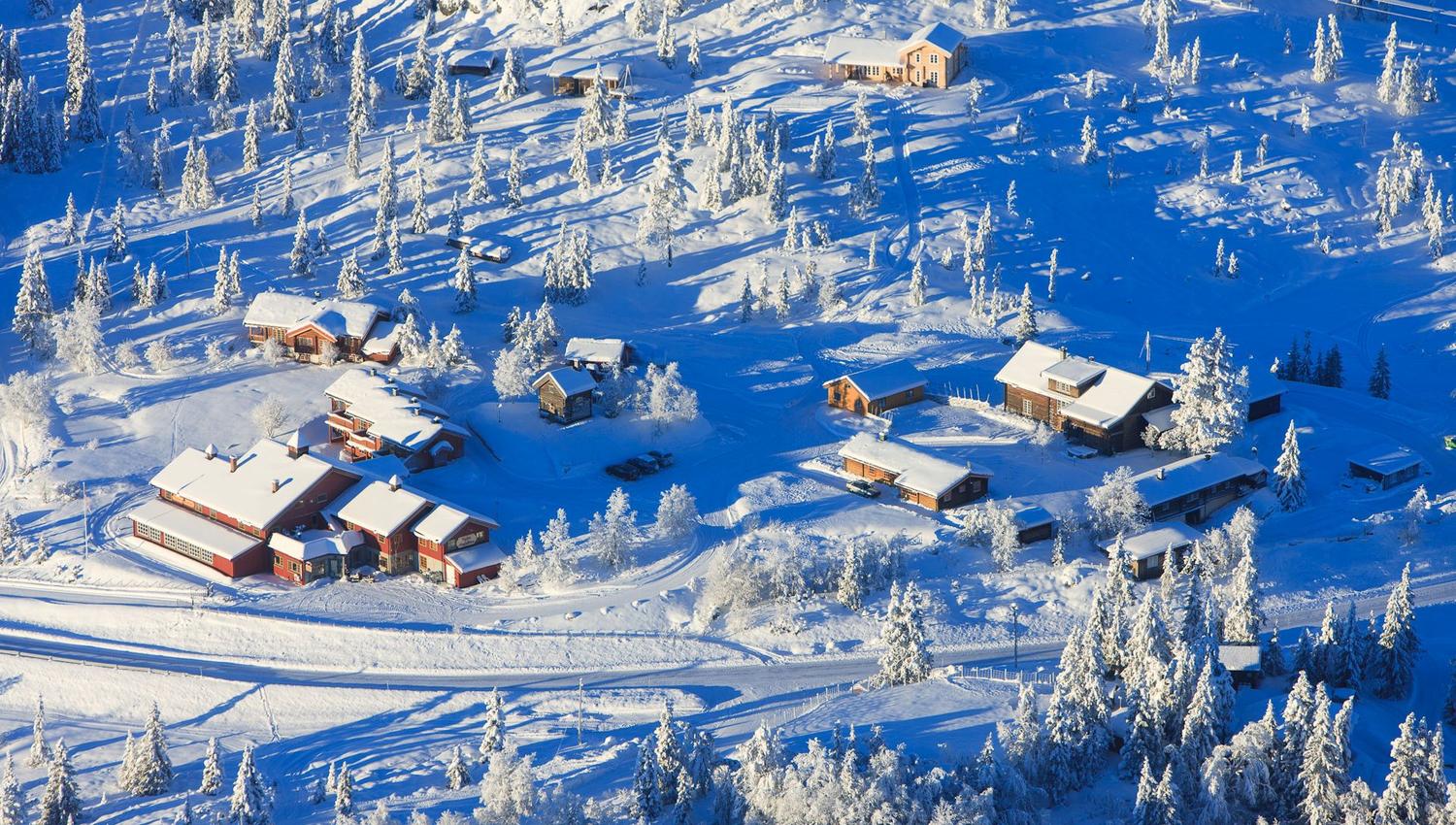 "Nythun" surrounded with snow from a birds view on a beautiful day
