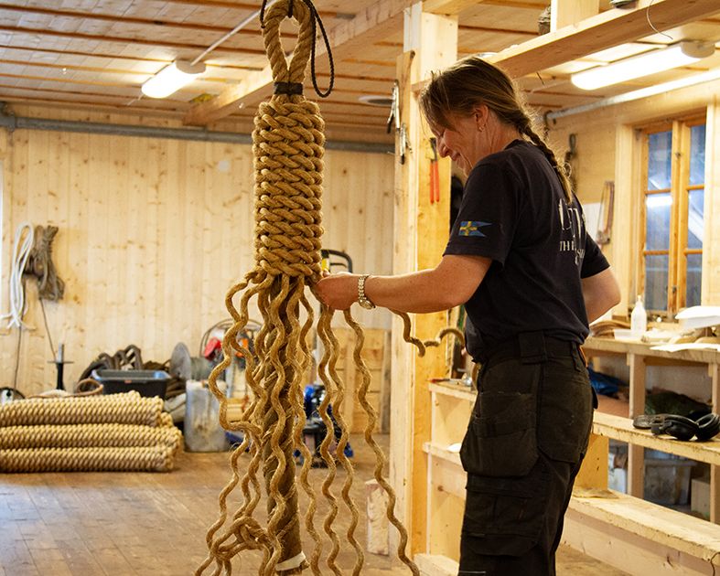 A woman making ropes in the workshop at Hardanger Maritime Center.