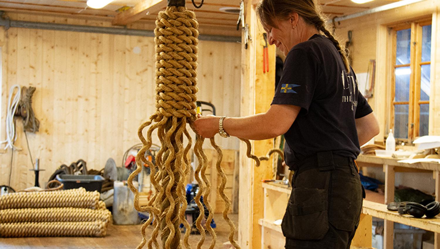 A woman making ropes in the workshop at Hardanger Maritime Center.