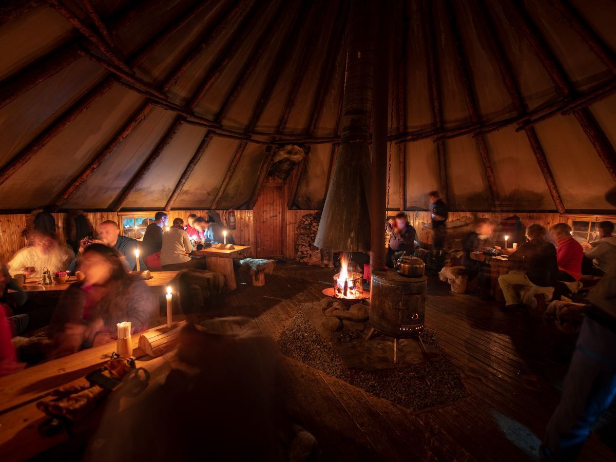 Guests enjoying a meal inside the lavvo