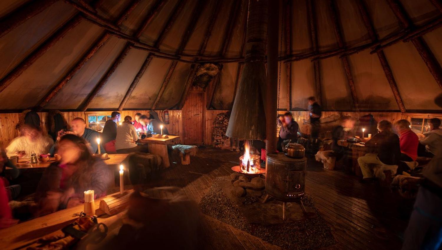 Guests enjoying a meal inside the lavvo