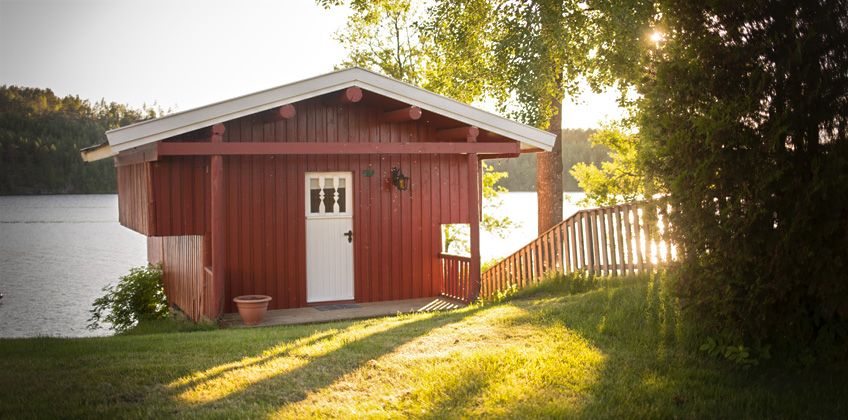 Small cabin with sun in the background