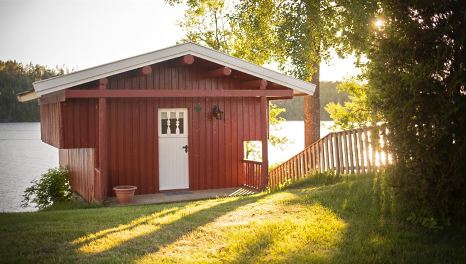 Small cabin with sun in the background