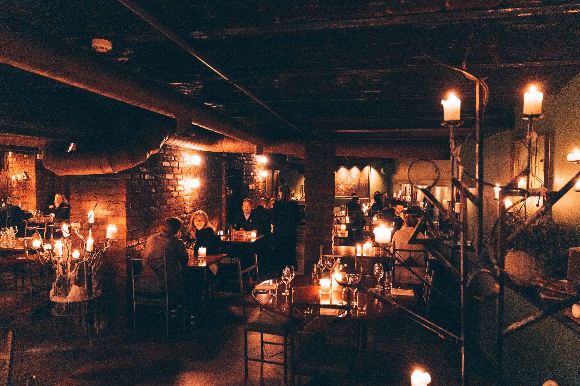 People sitting and dining in a cellar restaurant