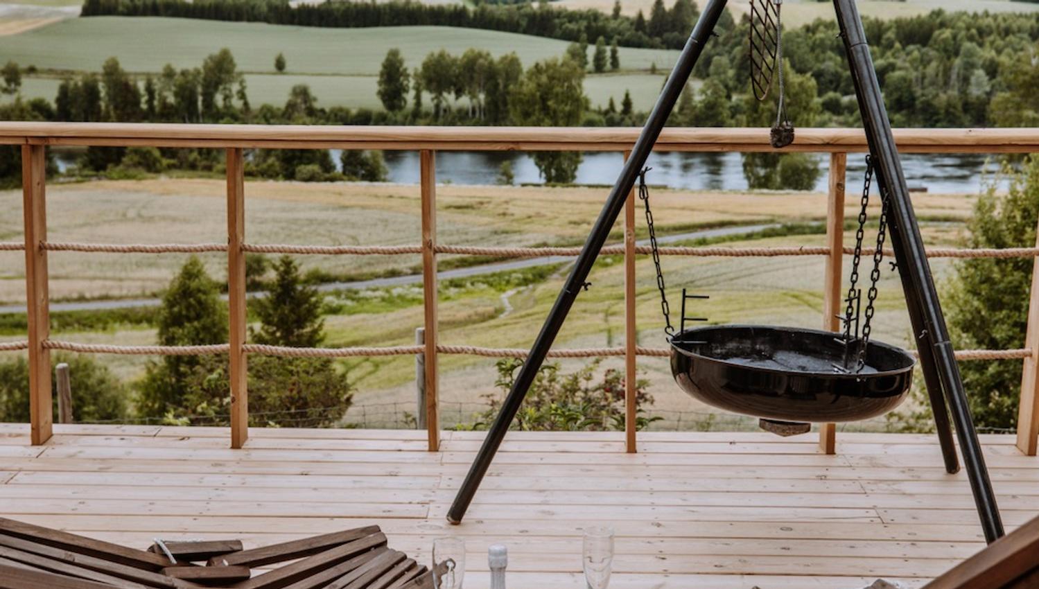 view from a terrace with a barbeque and some charis