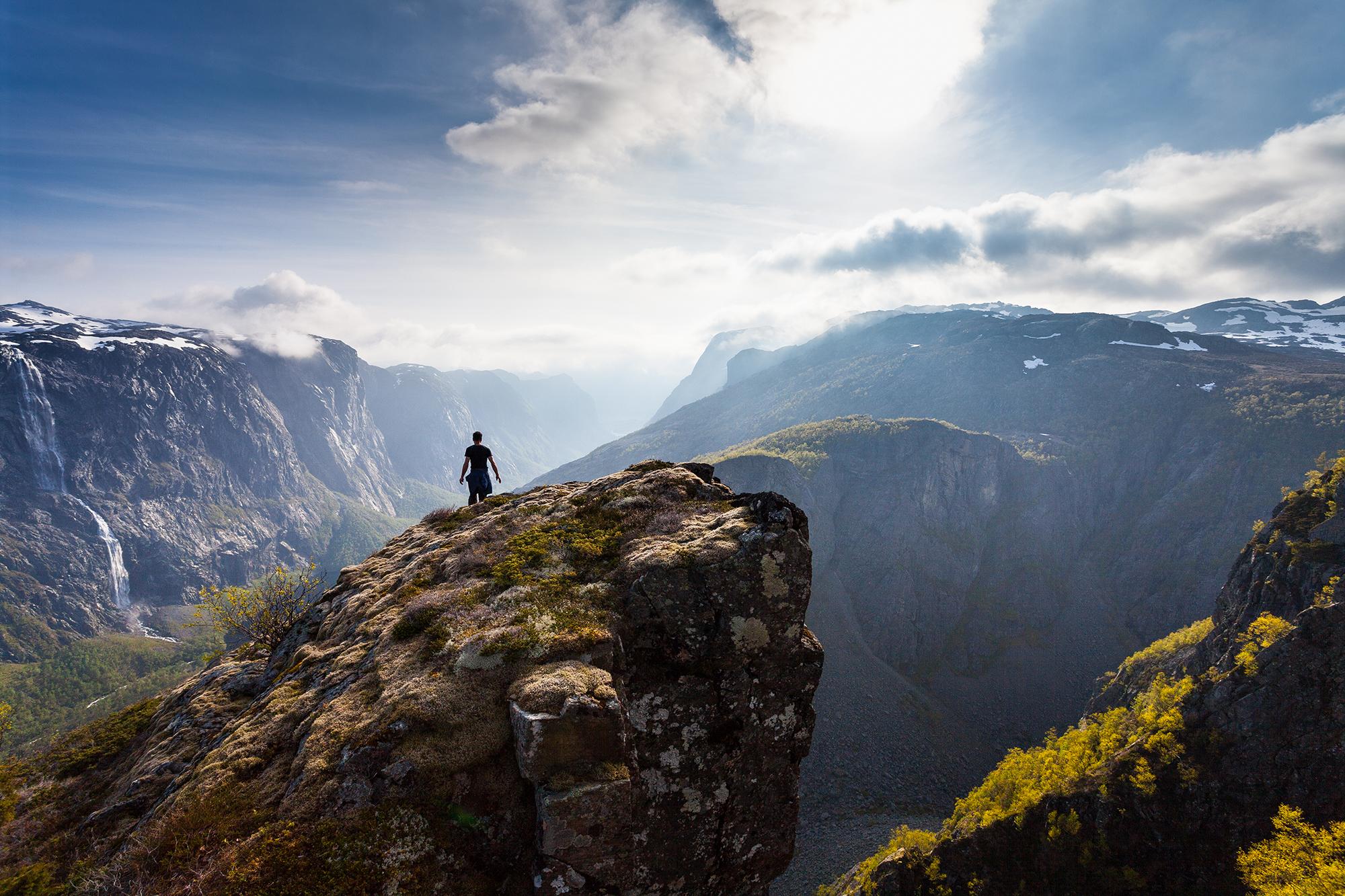 Person on rock formation near Fossjuvet in Forsand, Fjord Norway