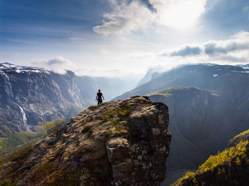 Person on rock formation near Fossjuvet in Forsand, Fjord Norway
