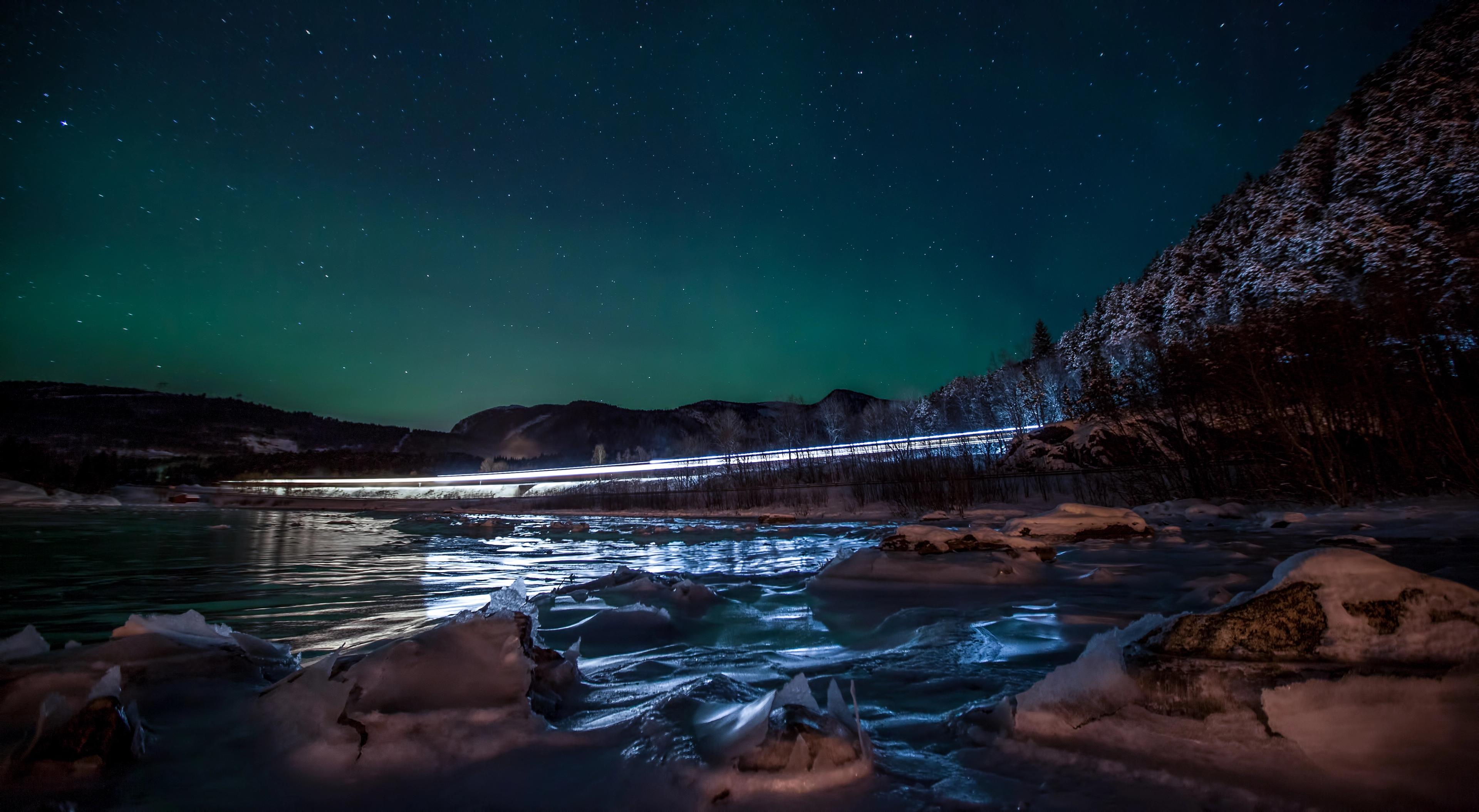 The Nordland railway train runs under the northern lights on its way from Trondheim to Bodø, Norway