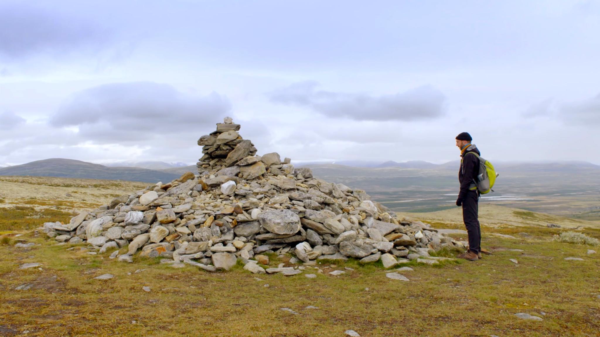 Kes Blans in front of the large cairn Allmannsrøysa in the Dovrefjell montains in Eastern Norway