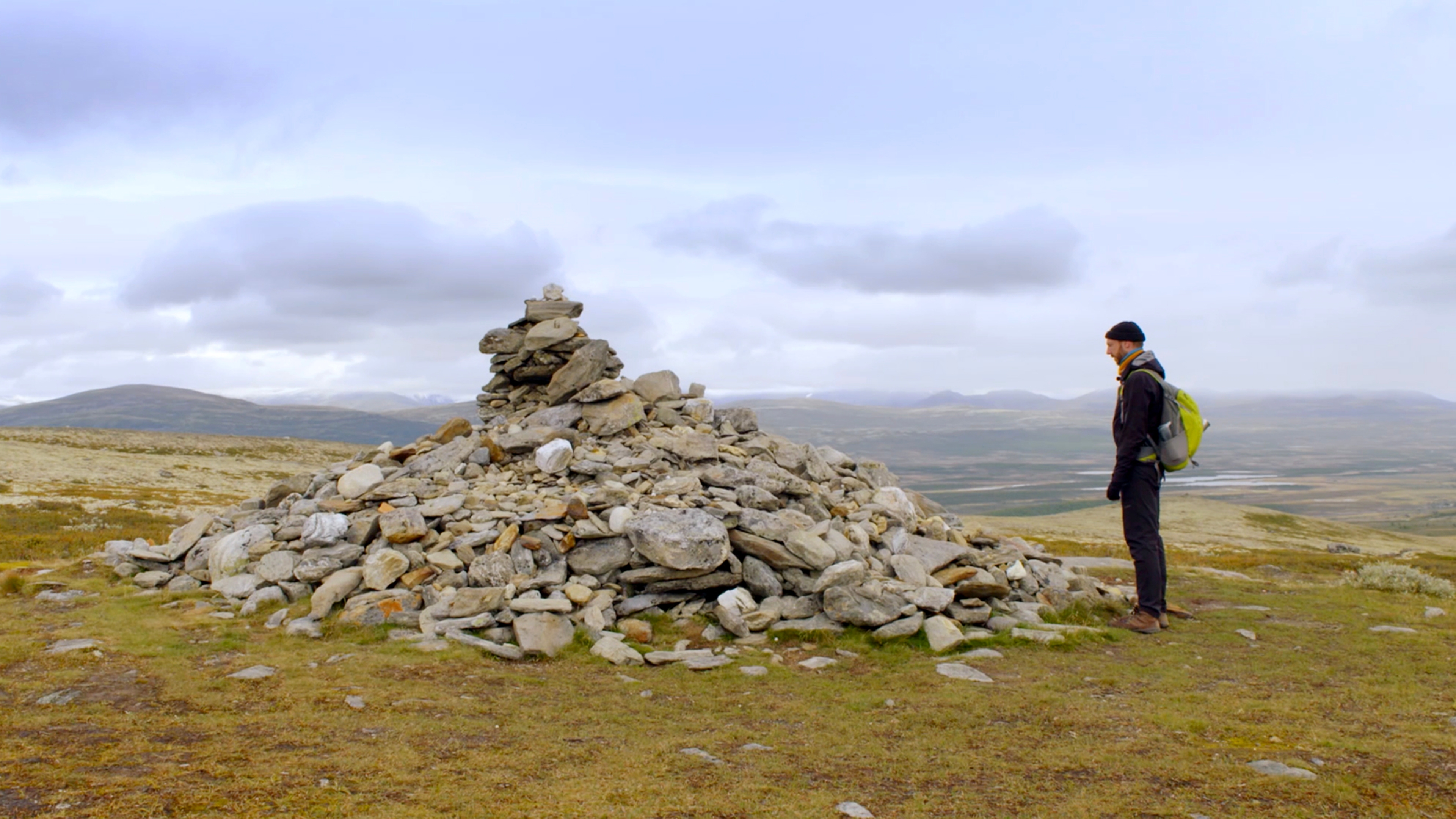 Kes Blans in front of the large cairn Allmannsrøysa in the Dovrefjell montains in Eastern Norway