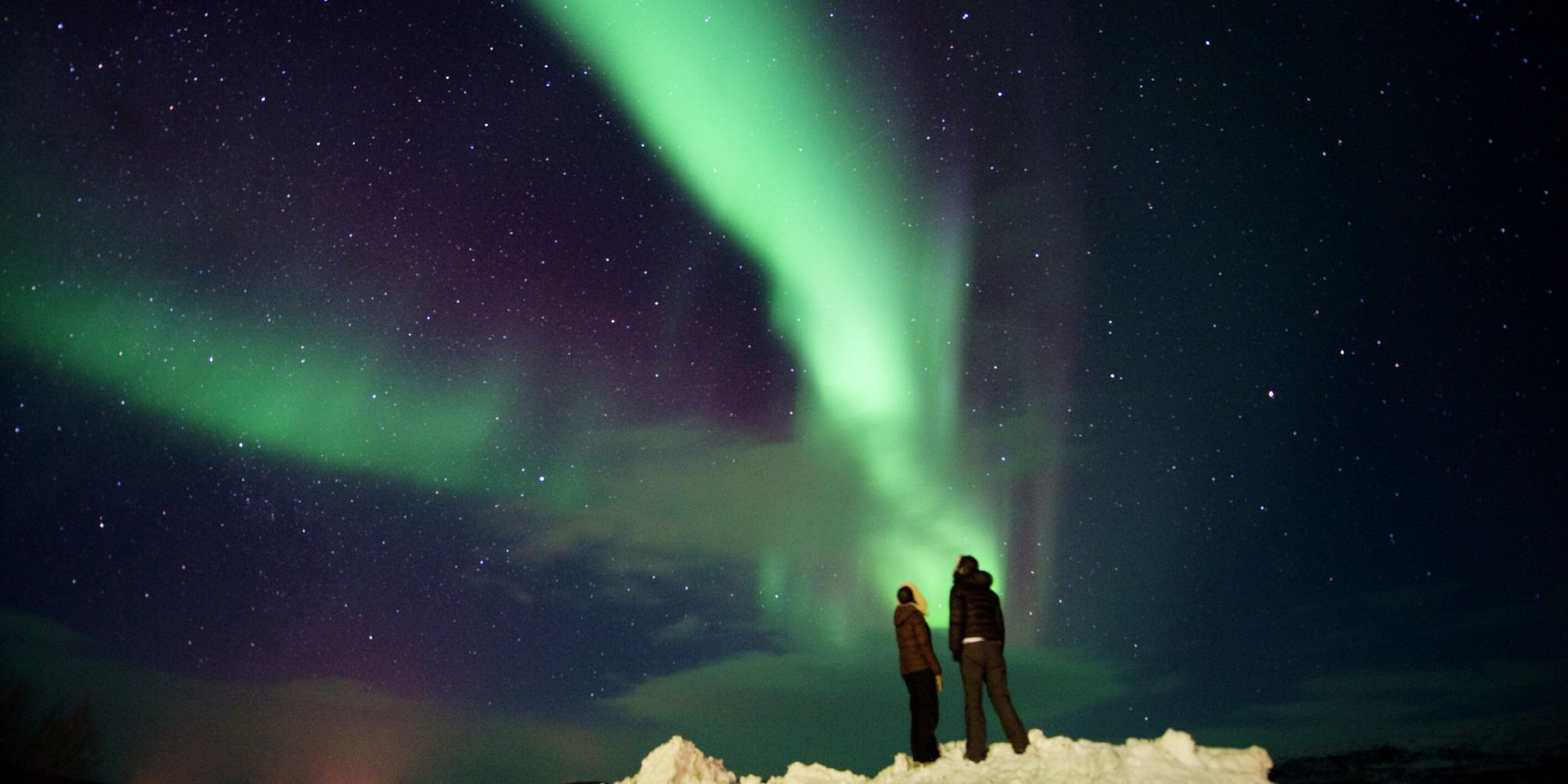 A couple looking at the northern lights in Finnmark
