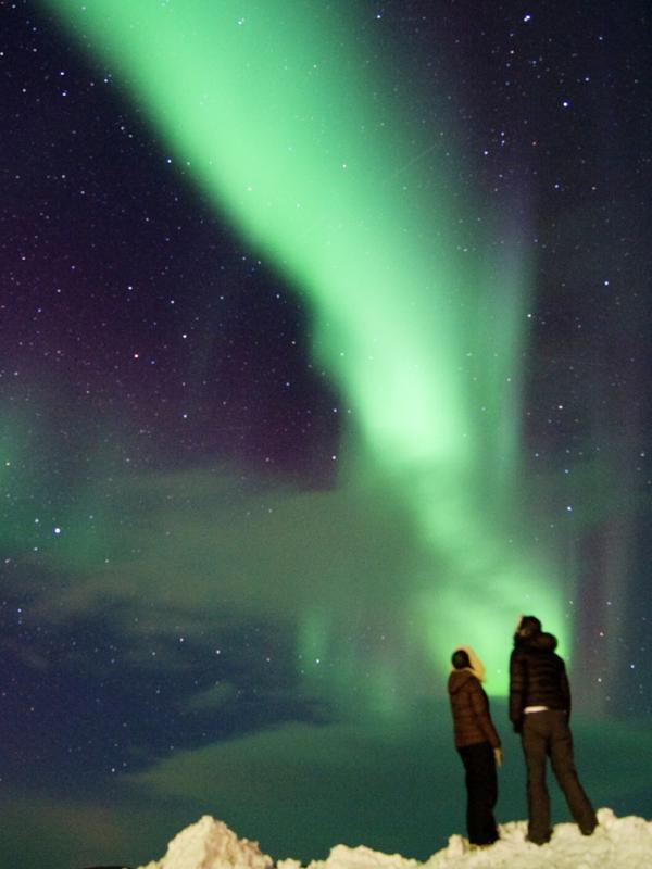 A couple looking at the northern lights in Finnmark