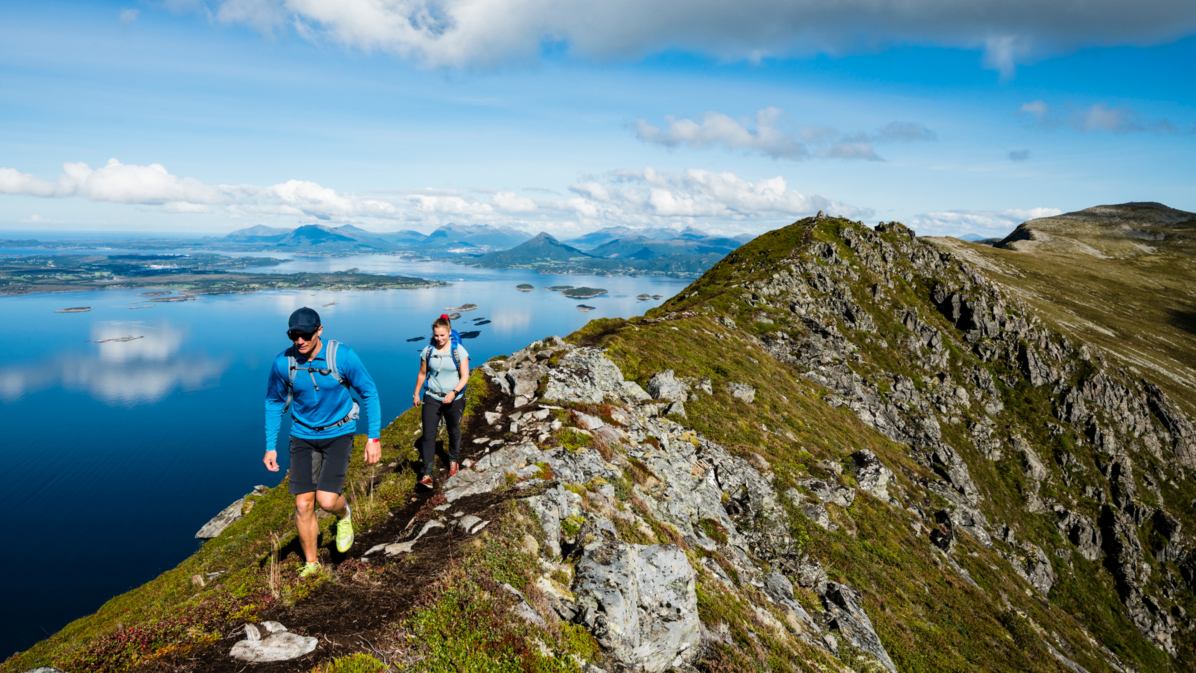 A man and a woman hiking up the Midsundtrappene in Molde in Northwest, Fjord Norway.