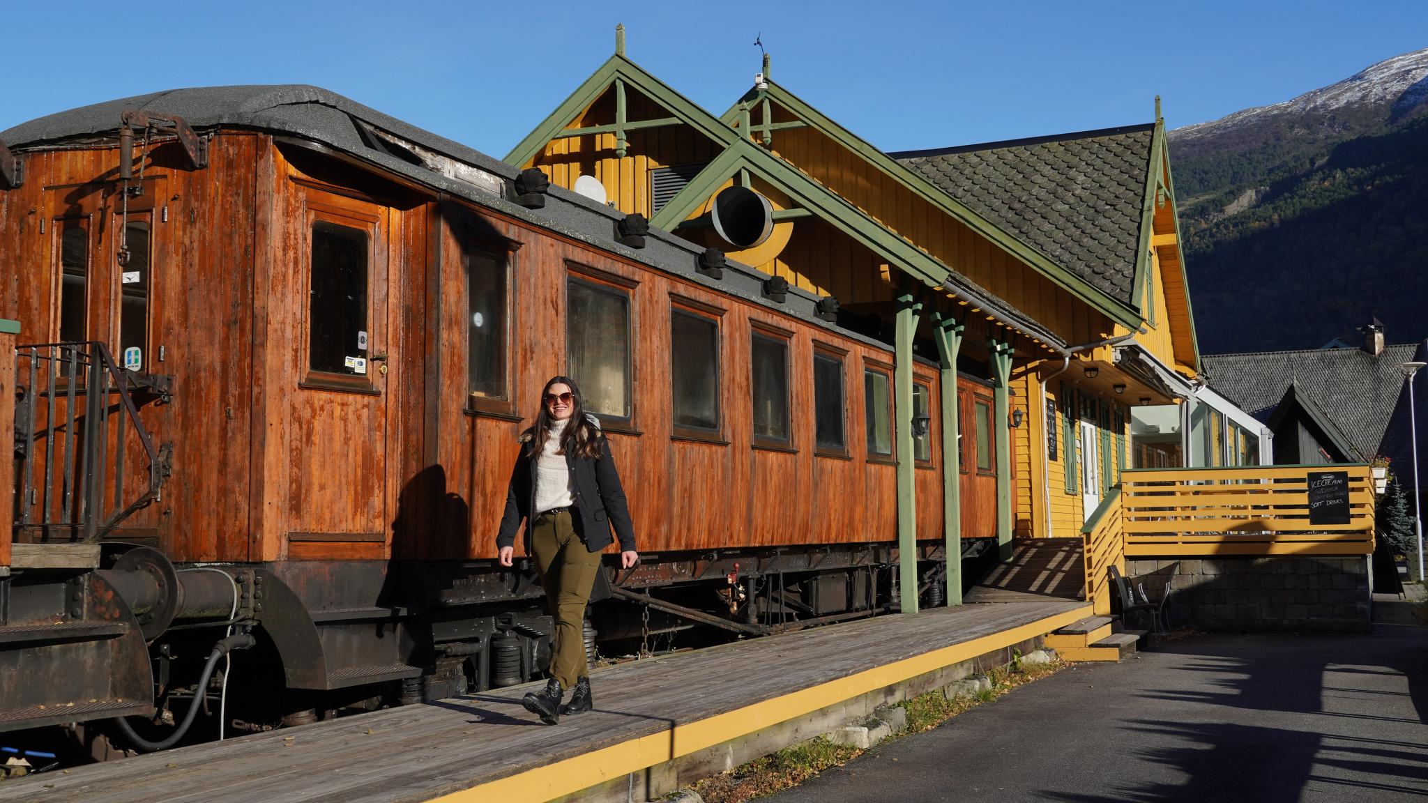 Woman in front of museum train.