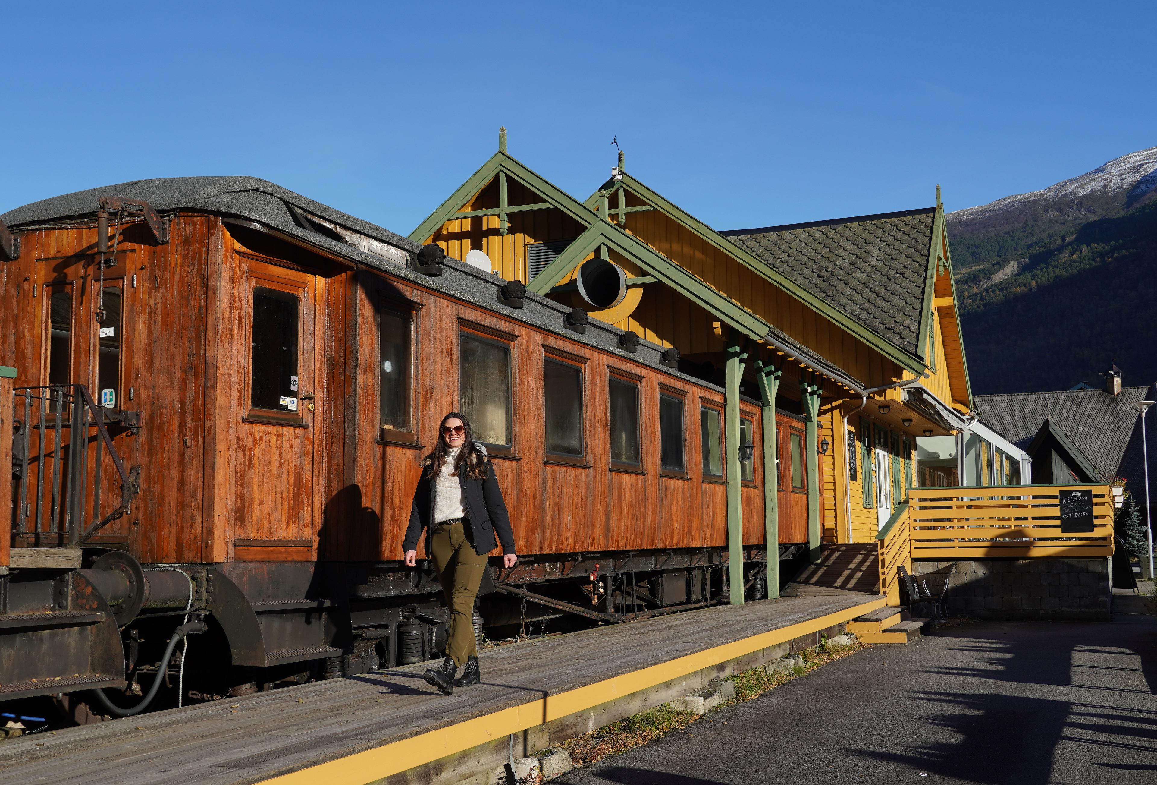 Woman in front of museum train.