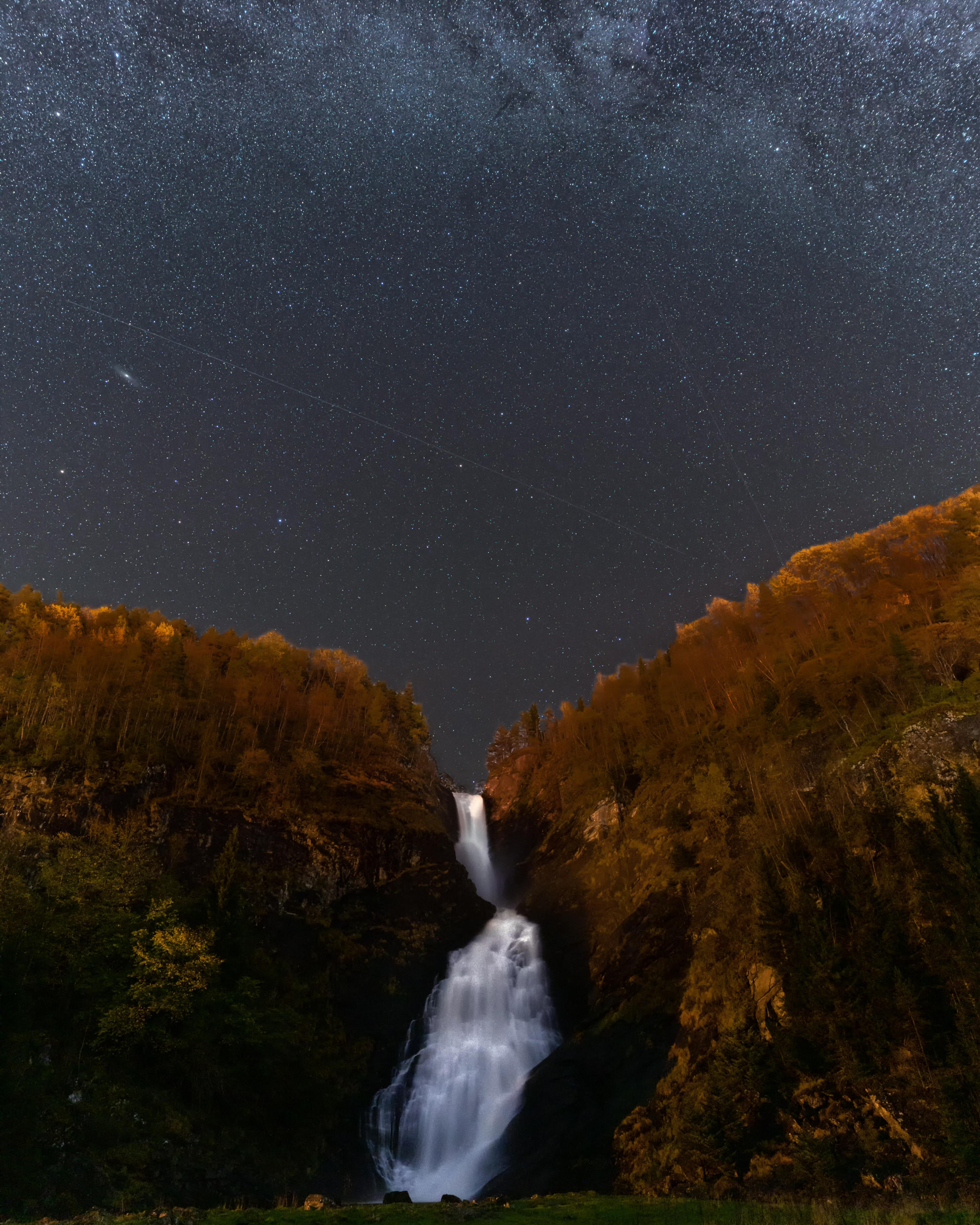 A waterfall under a starry night