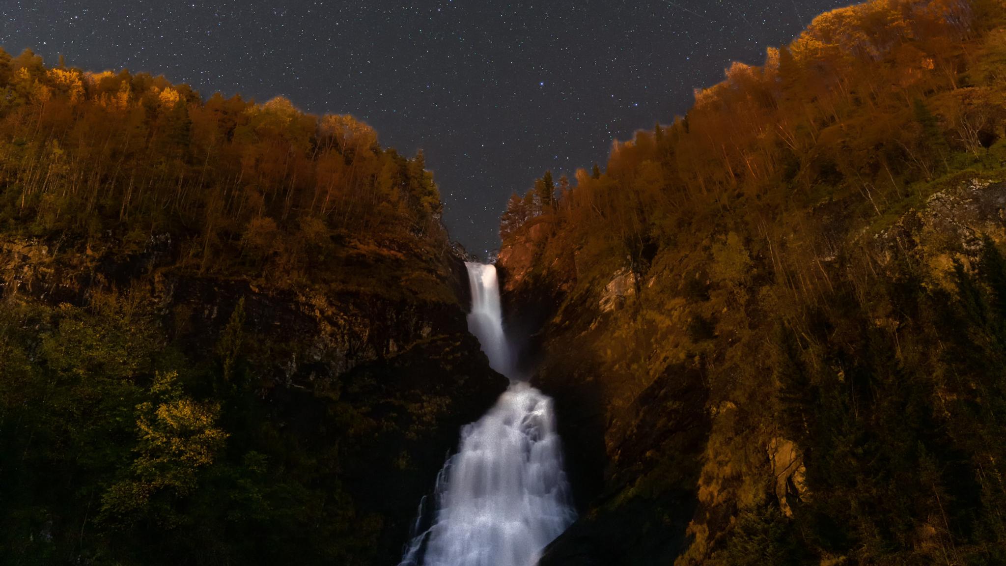 A waterfall under a starry night