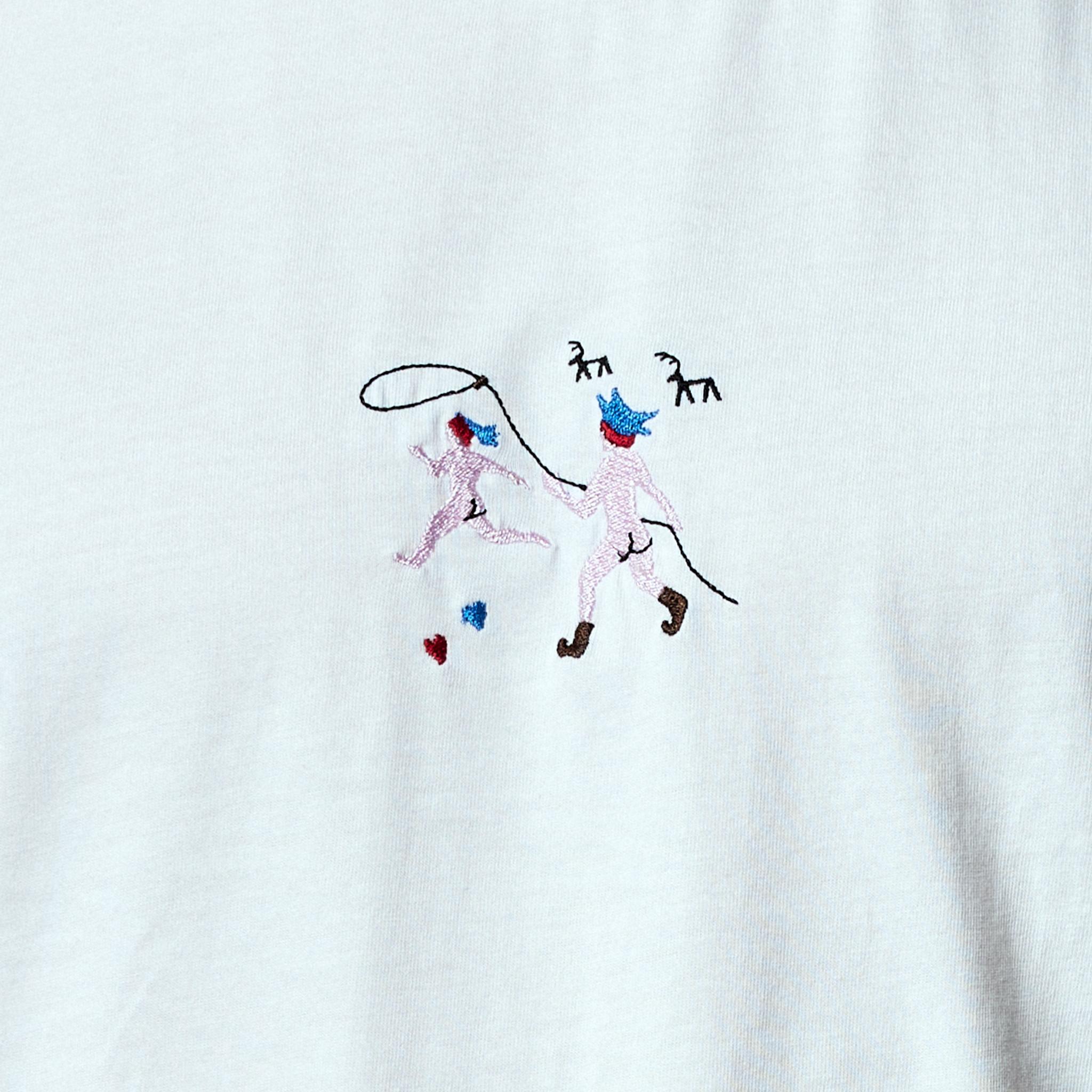 Embroidery of a naked Sami chasing another with a lasso