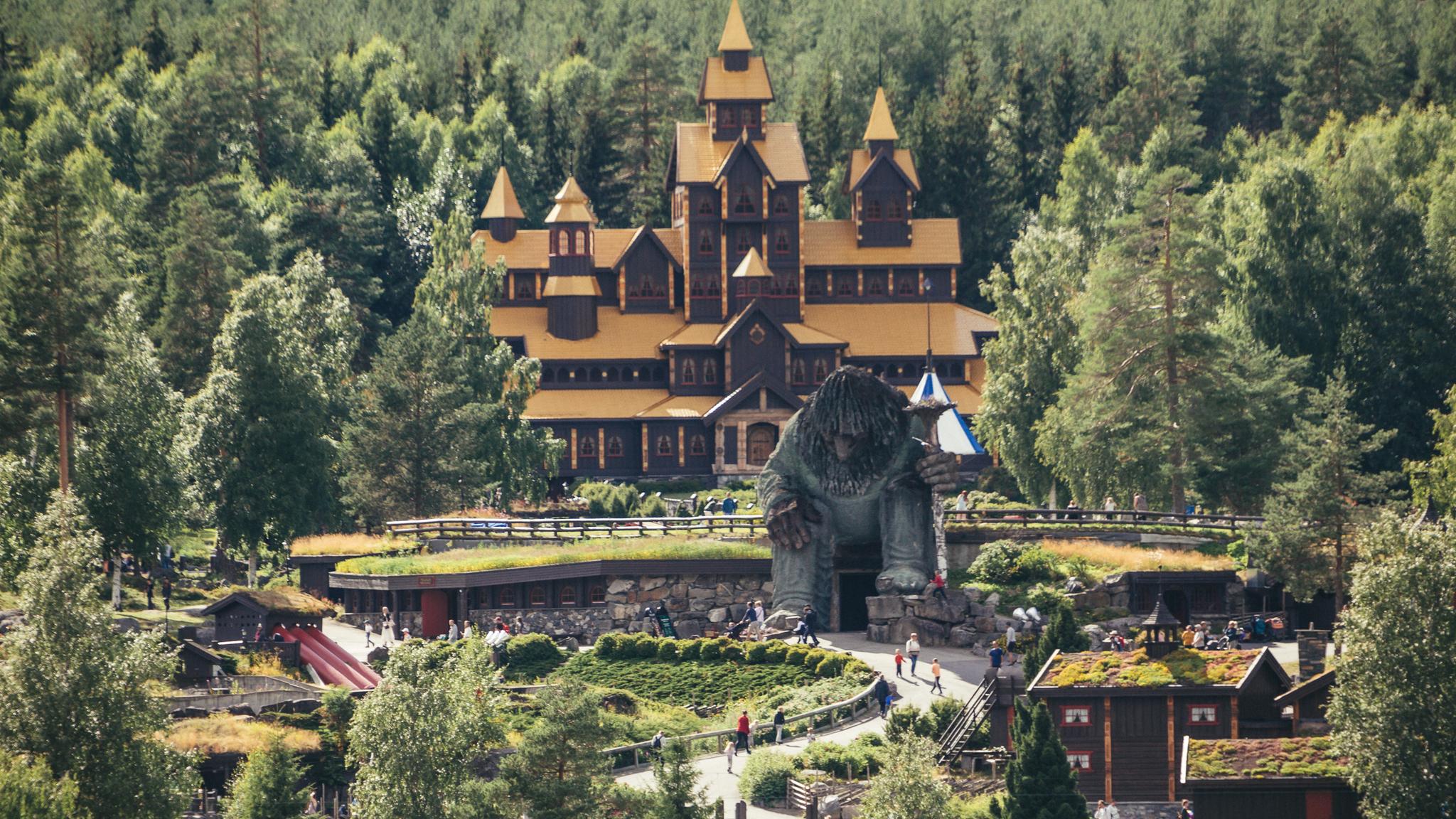 A view of Hunderfossen fairytale park with the Hunderfossen troll in front of the fairytale castle
