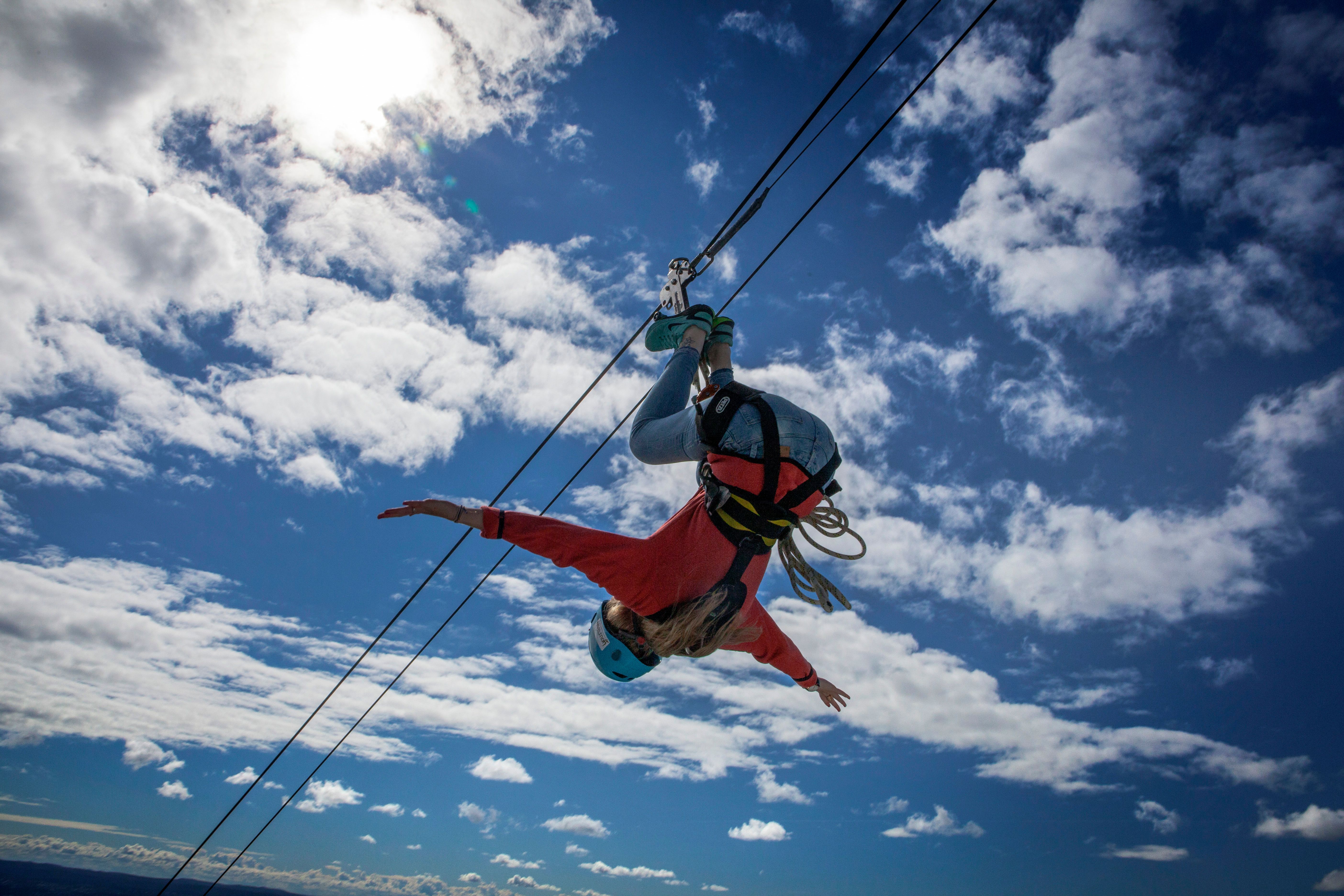 Woman ziplining upside down