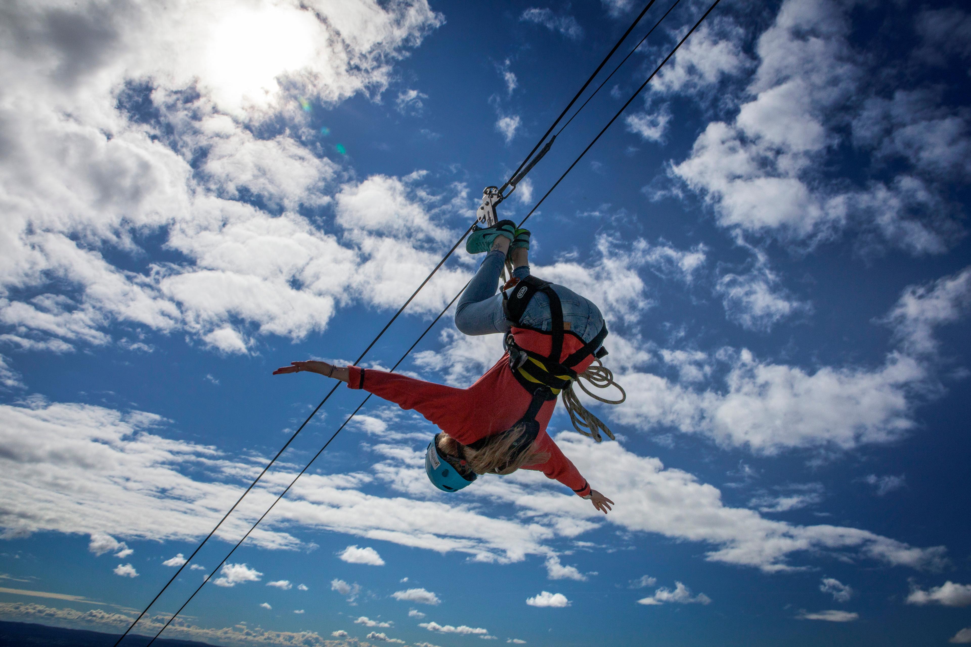 Woman ziplining upside down