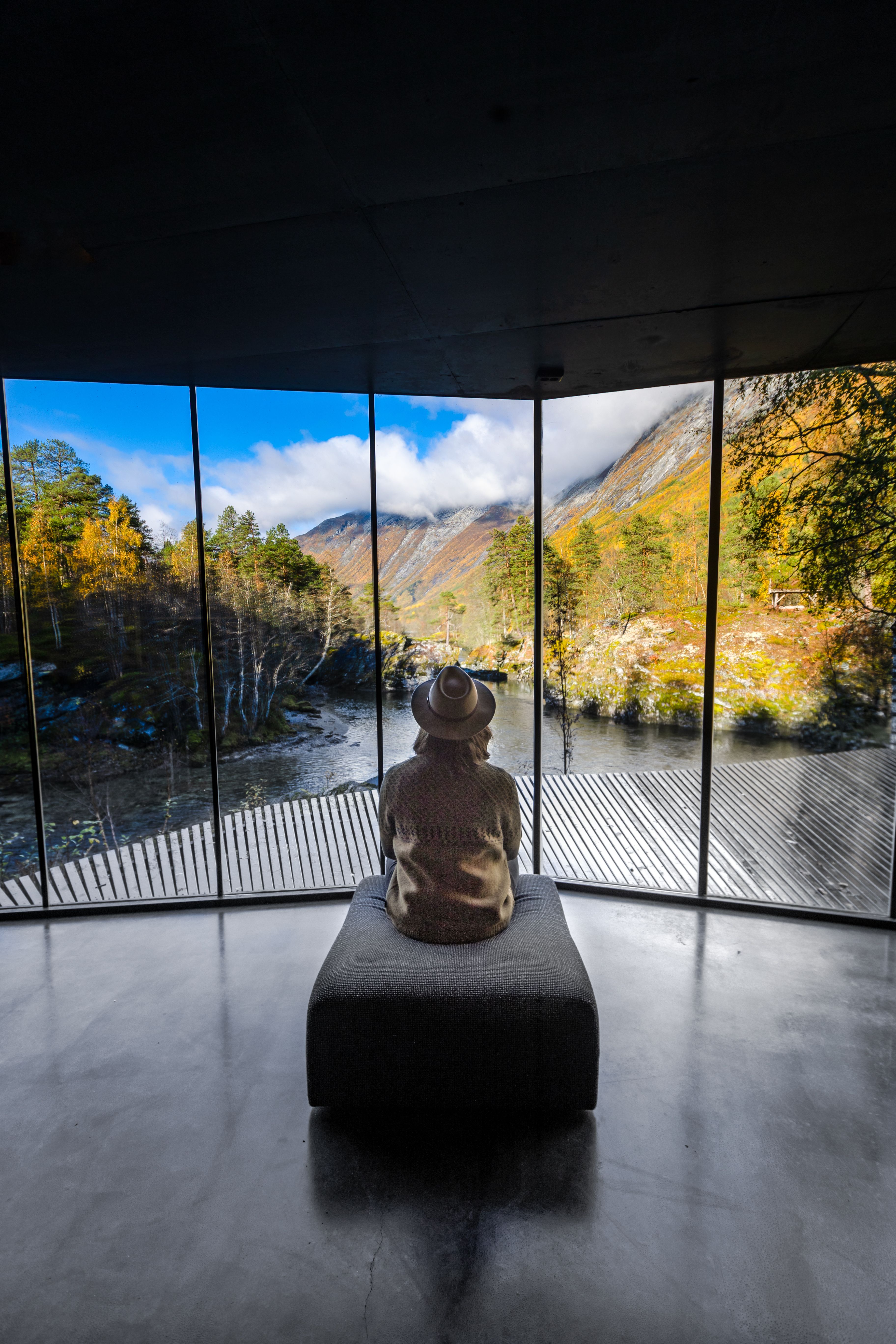 A woman looking at the view from Juvet Landscape Hotel in Valldal in Fjord Norway.