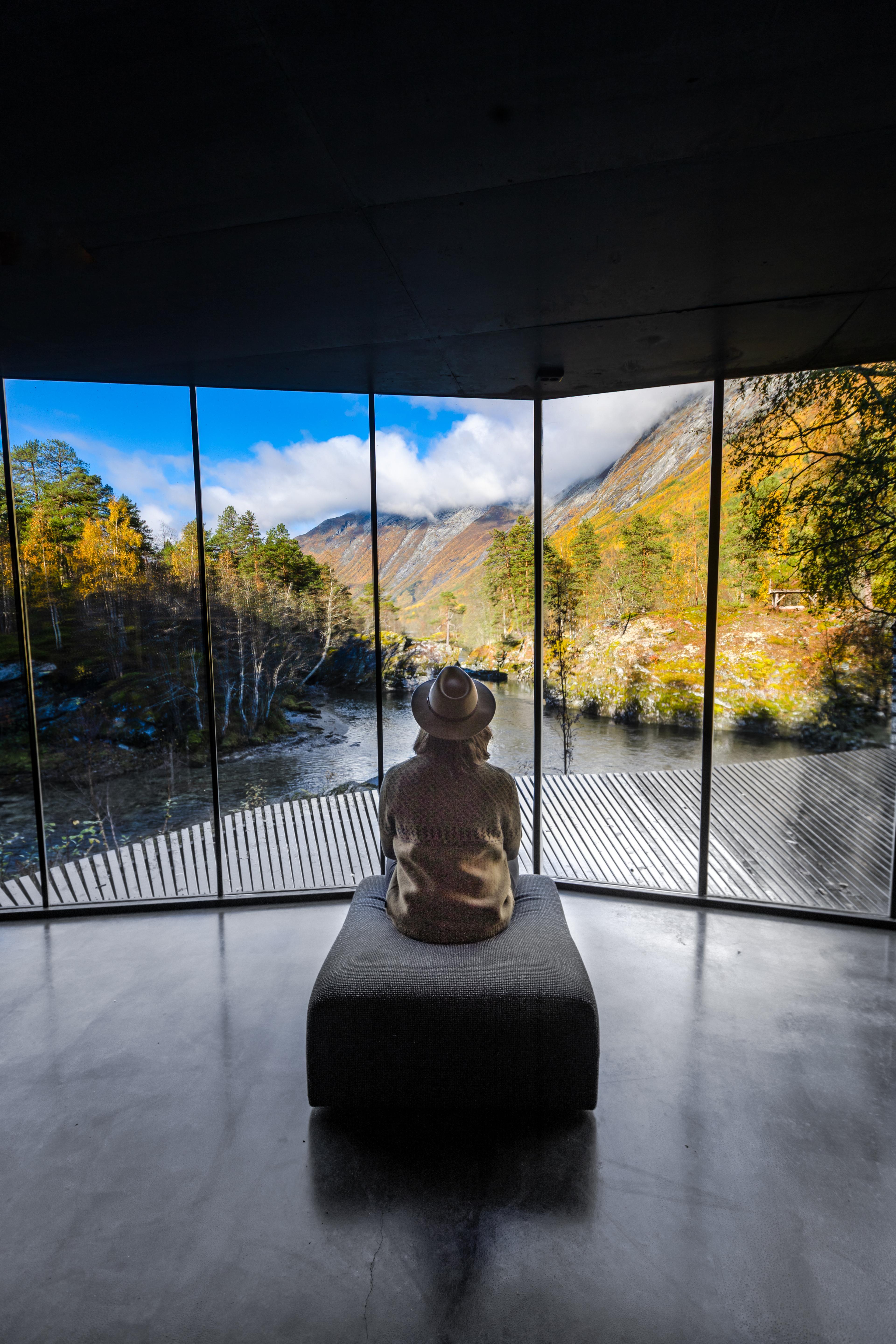 A woman looking at the view from Juvet Landscape Hotel in Valldal in Fjord Norway.