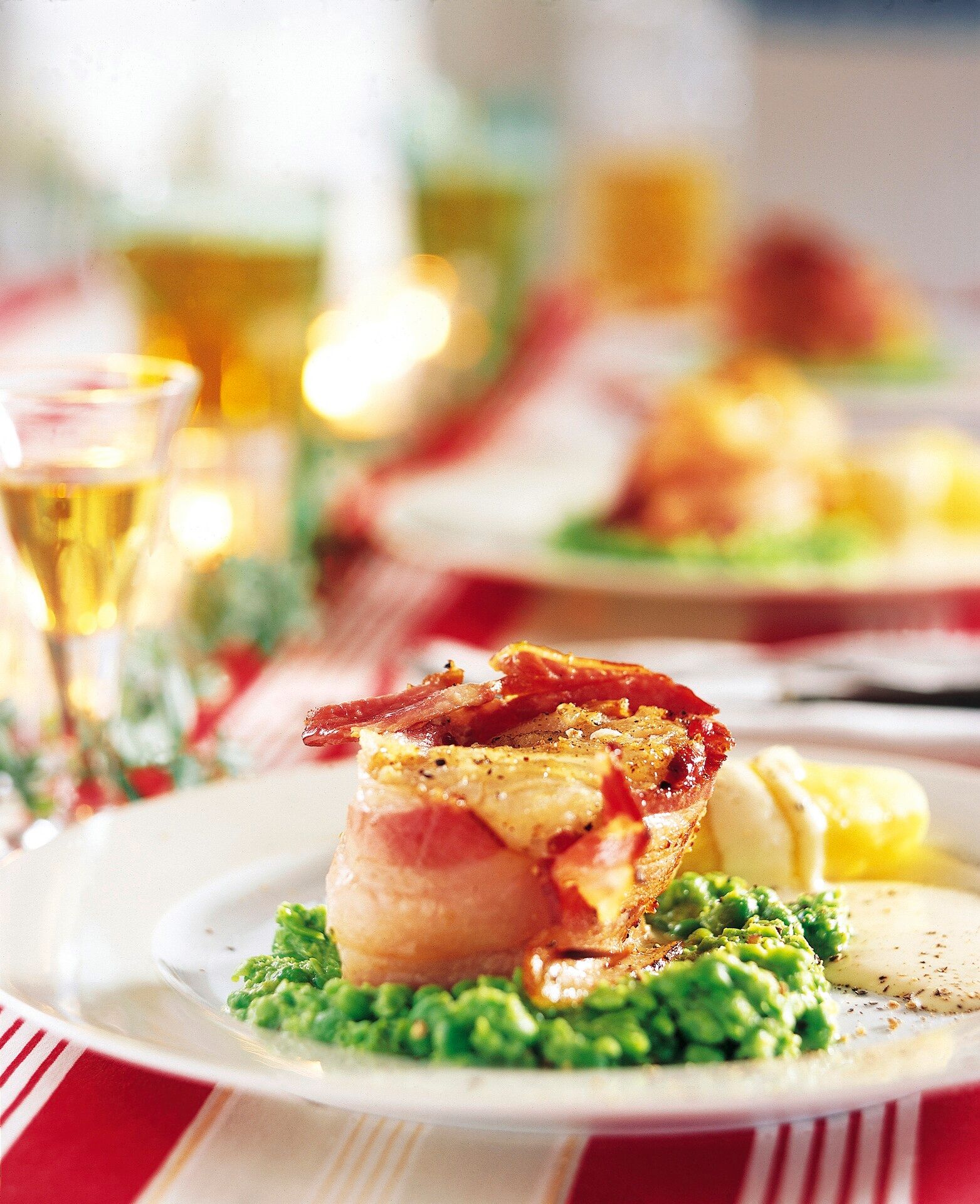 A serving of lutefisk with bacon, peas and potatos