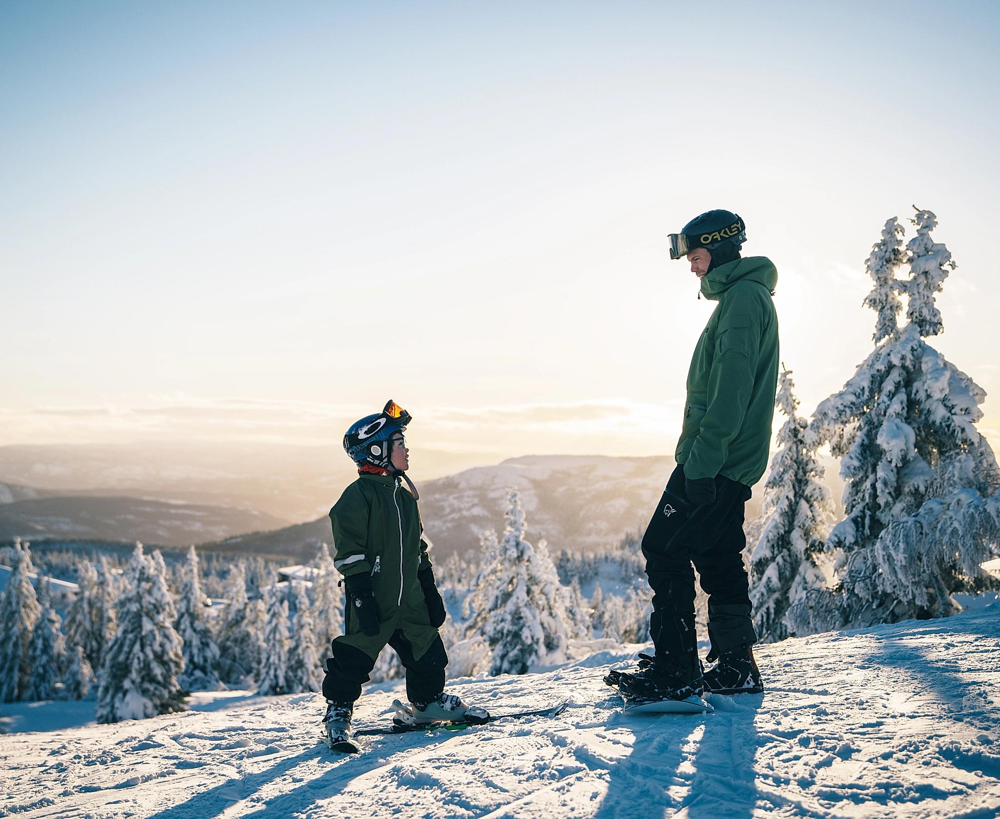 Kid and man skiing at Lifjell ski resort