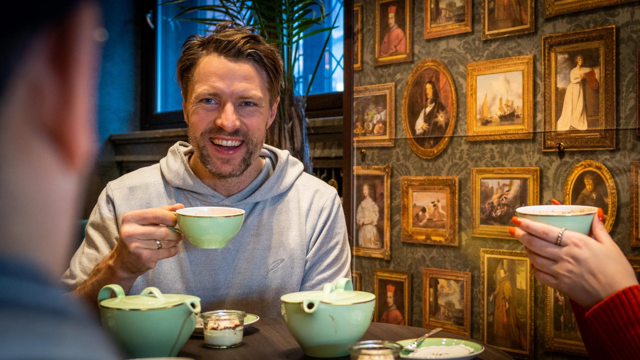 A man is enjoying a hot chocolate on Hotel Bristol in Oslo, Eastern Norway