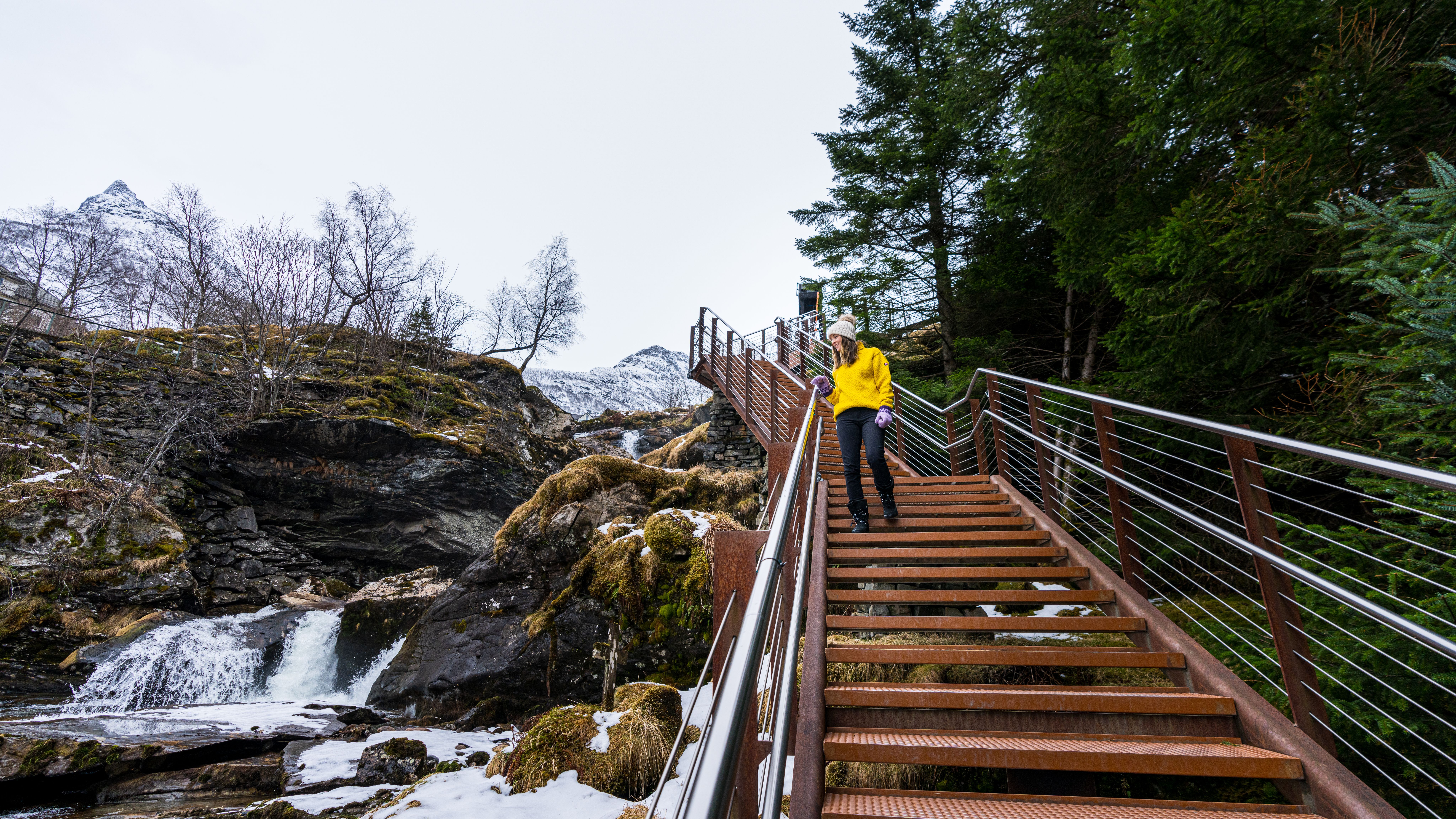 Woman walking along the Fosseråsa waterfall hike in Geiranger