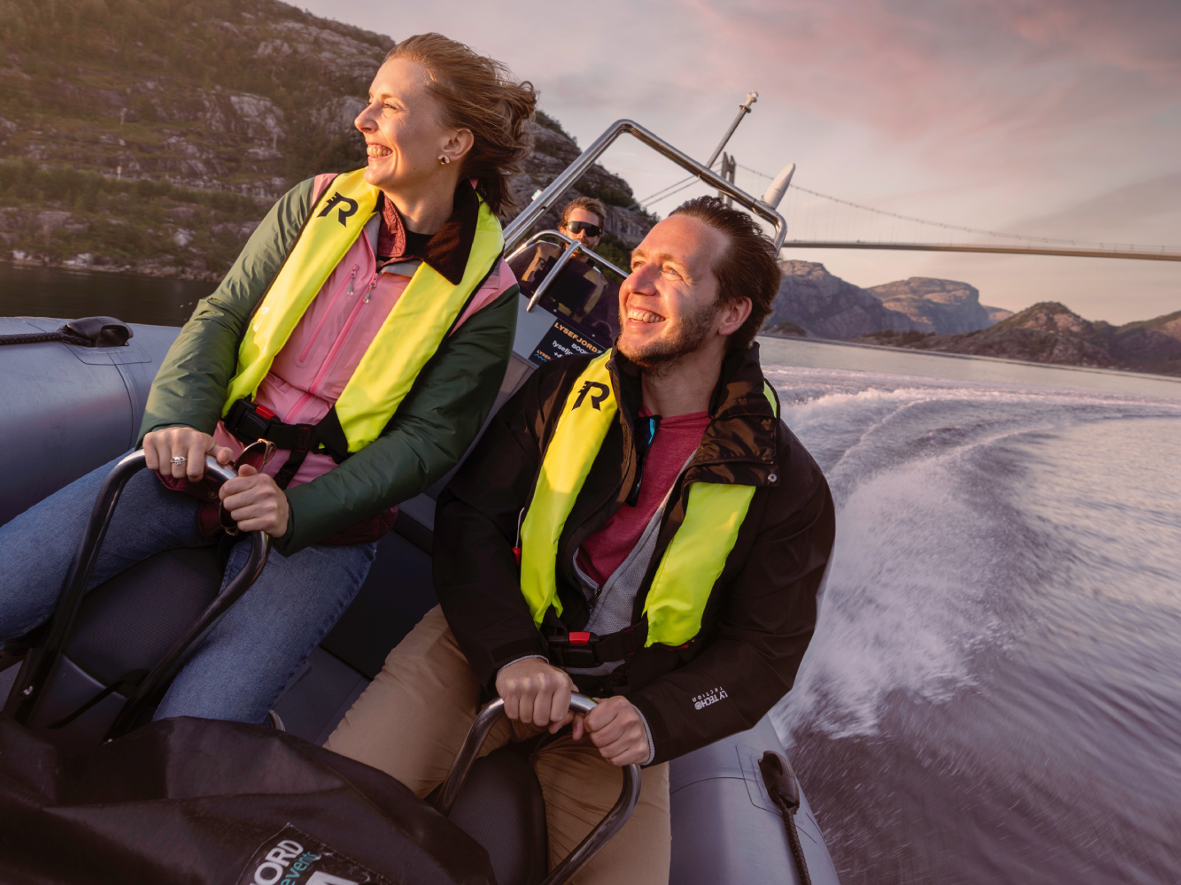 A man and a woman on a RIB boat out on the ocean in Stavanger