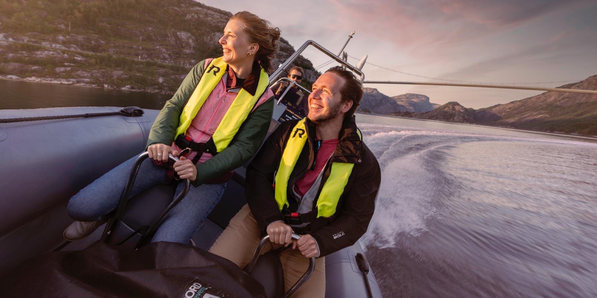 A man and a woman on a RIB boat out on the ocean in Stavanger