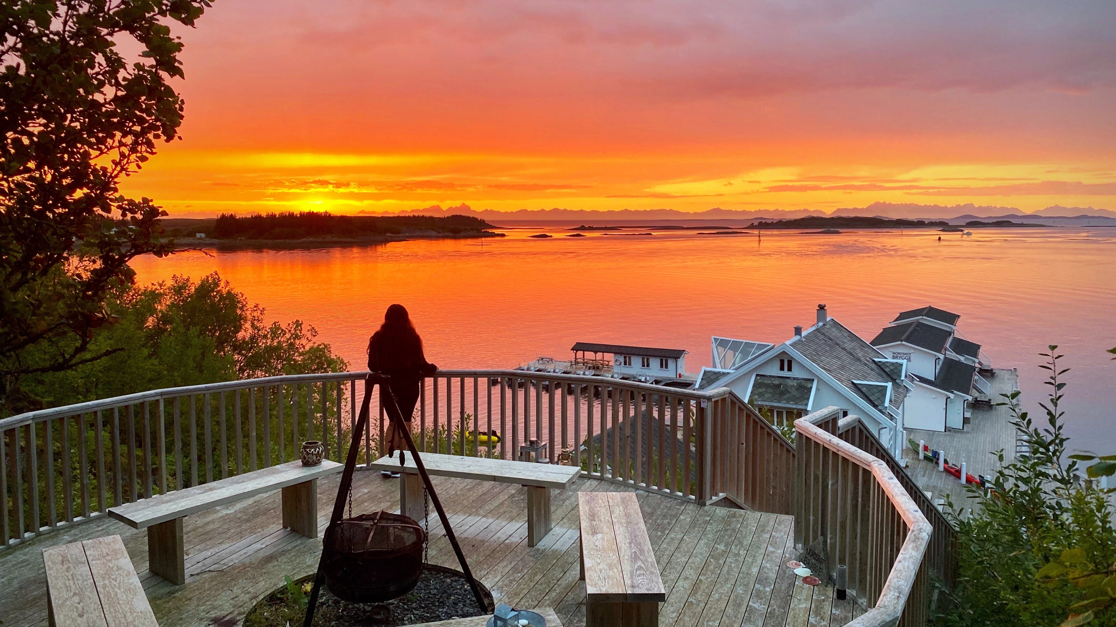Sunset and woman looking out on the sea.