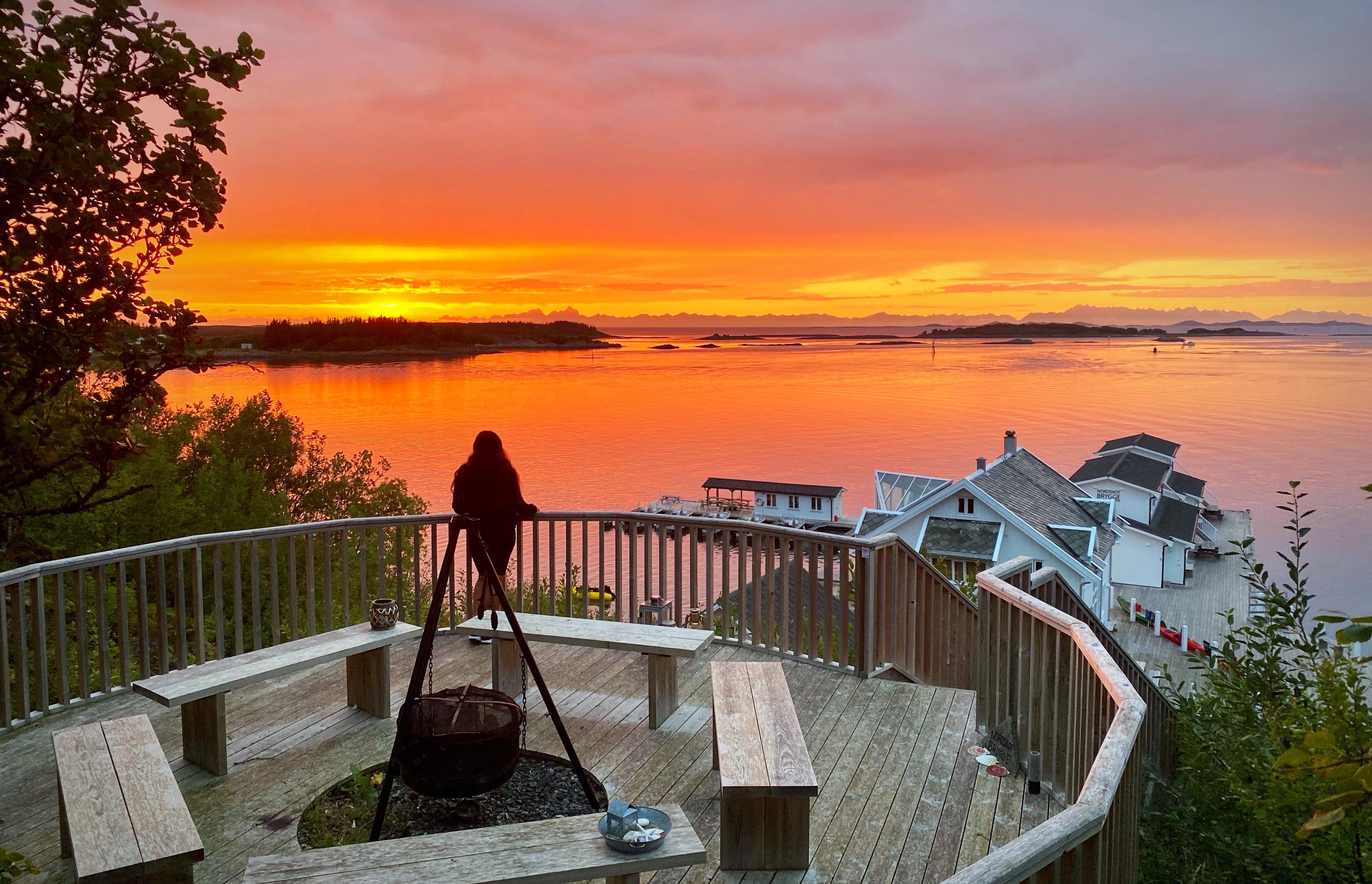 Sunset and woman looking out on the sea.