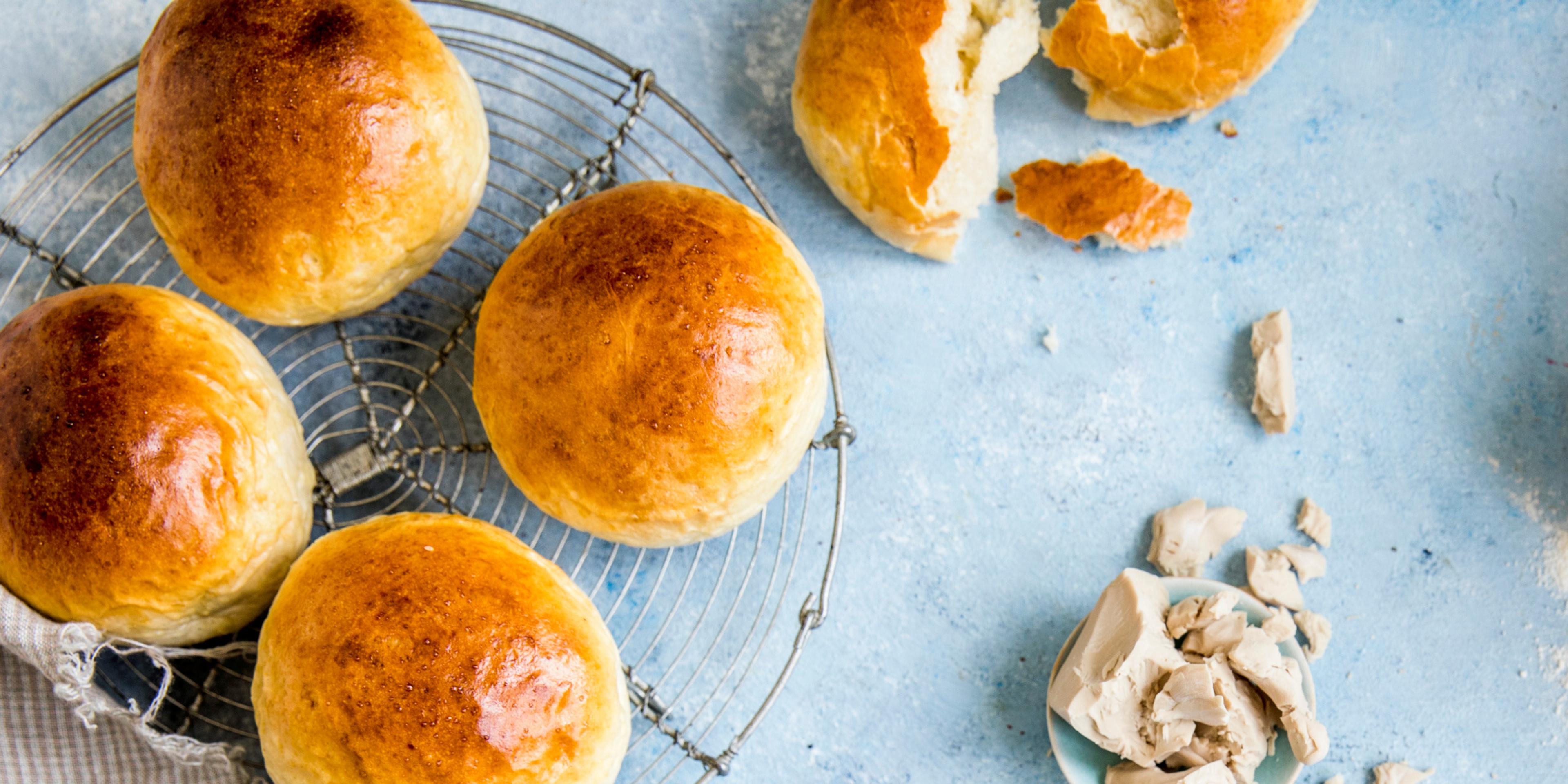 Wheat buns and ingredients on a table