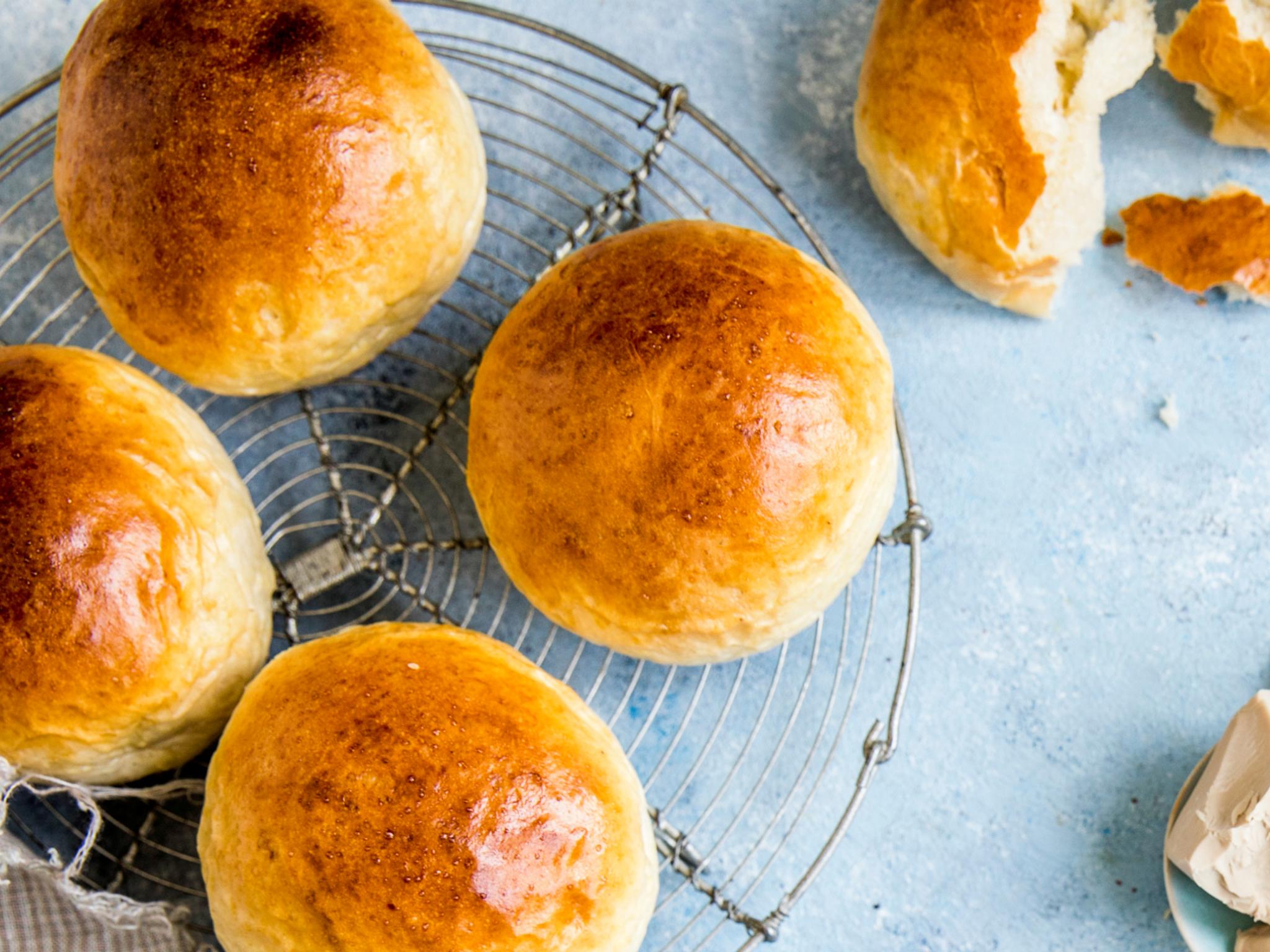 Wheat buns and ingredients on a table