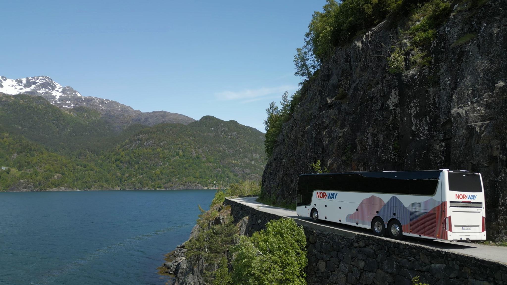 A bus driving by the fjord in Norway
