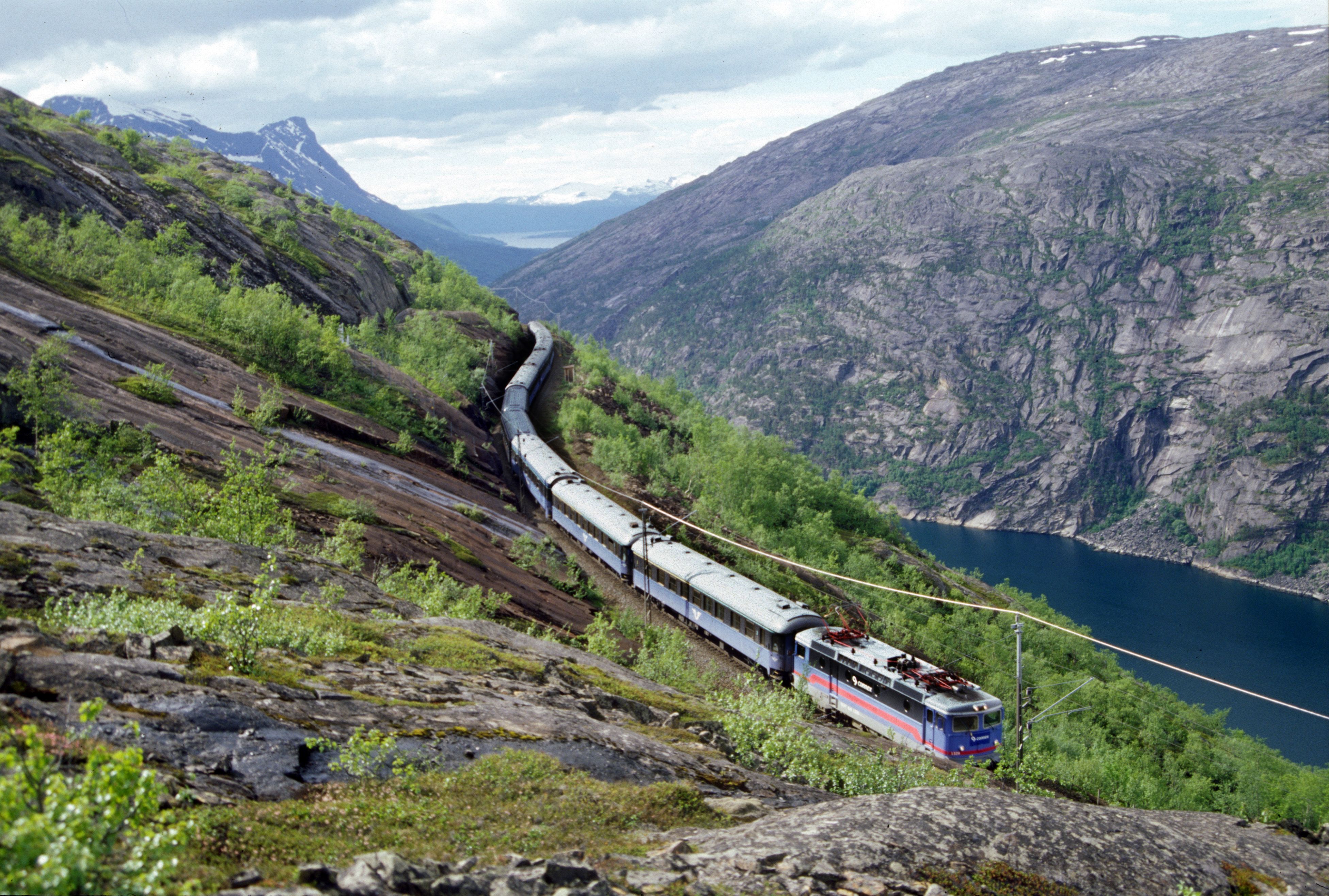 A train on the Ofotbanen in a beautiful river and mountain landscape, Northern Norway