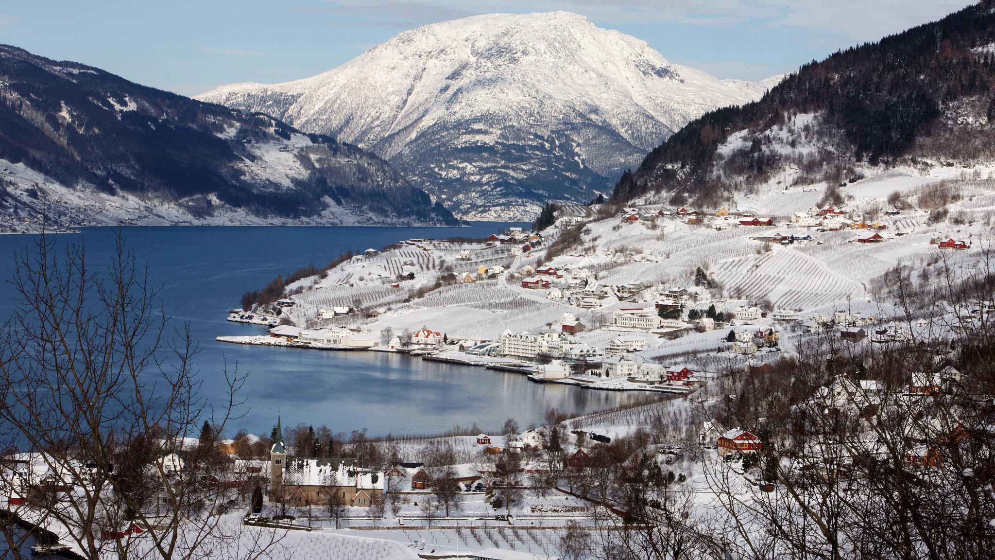 The charming village Lufthus by the Hardangerfjord in Fjord Norway, covered in snow.
