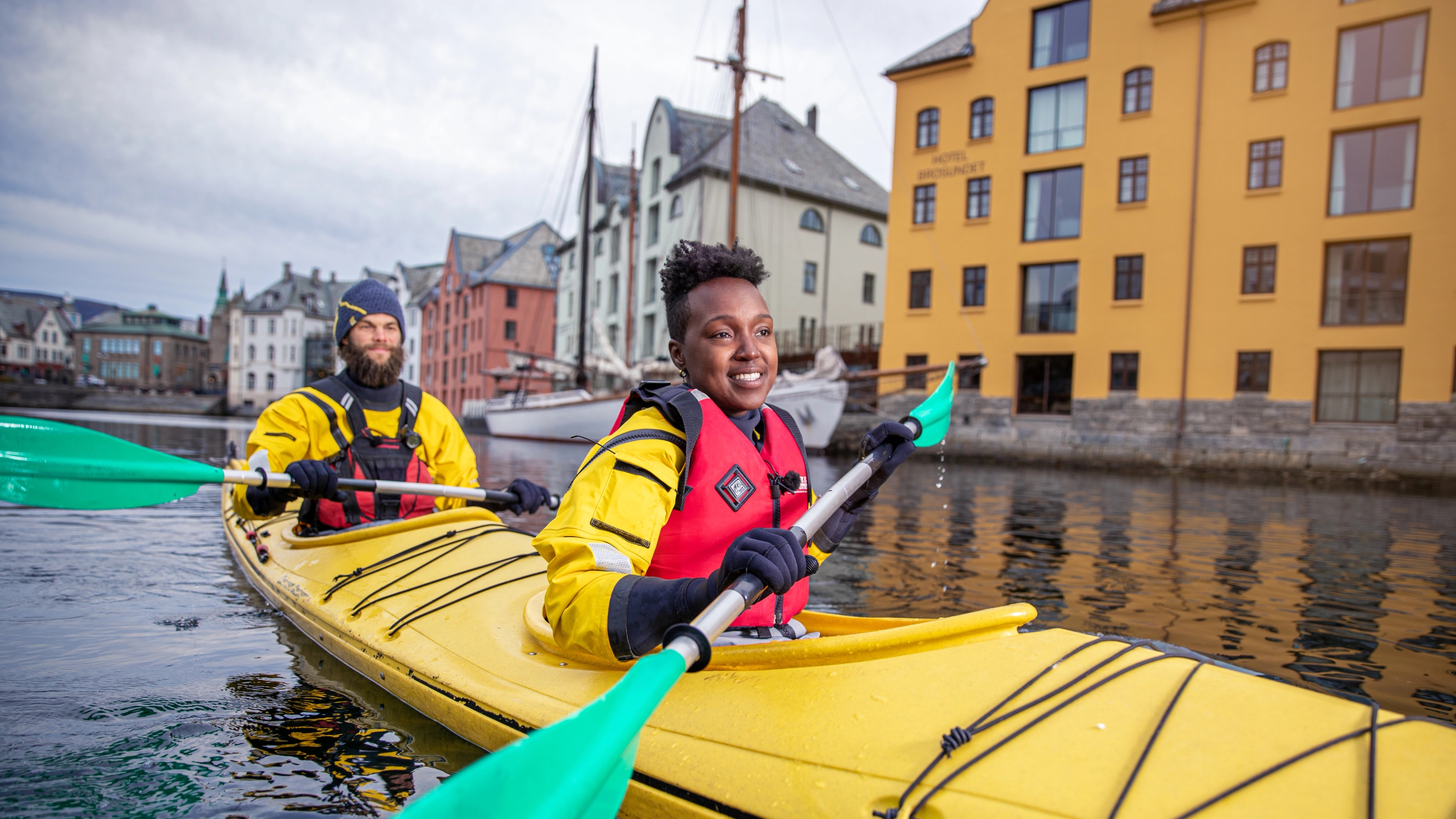 Go on city break in Ålesund Two people kayaking, Fjord Norway