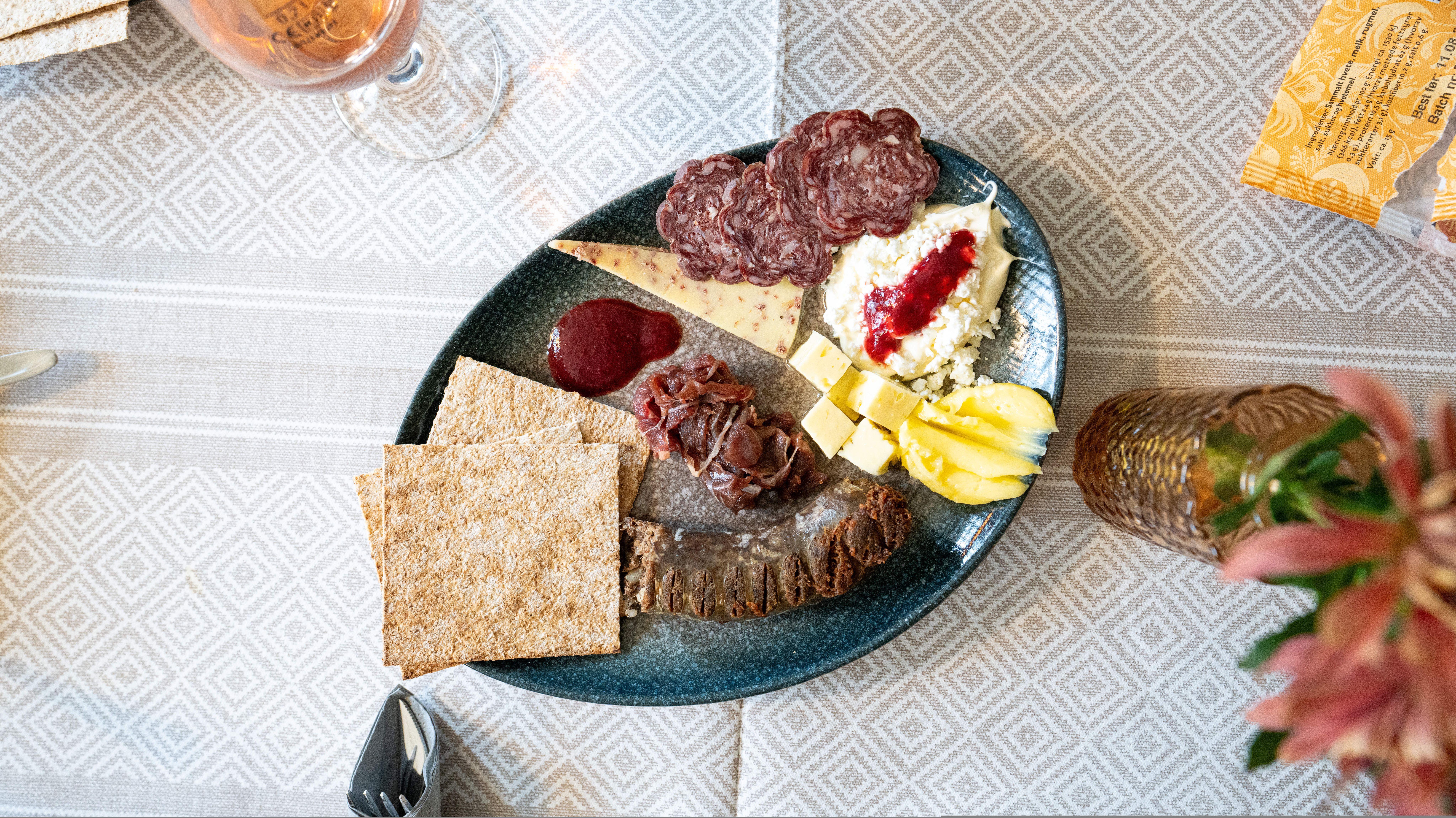 A plate full of dried meats and cheeses