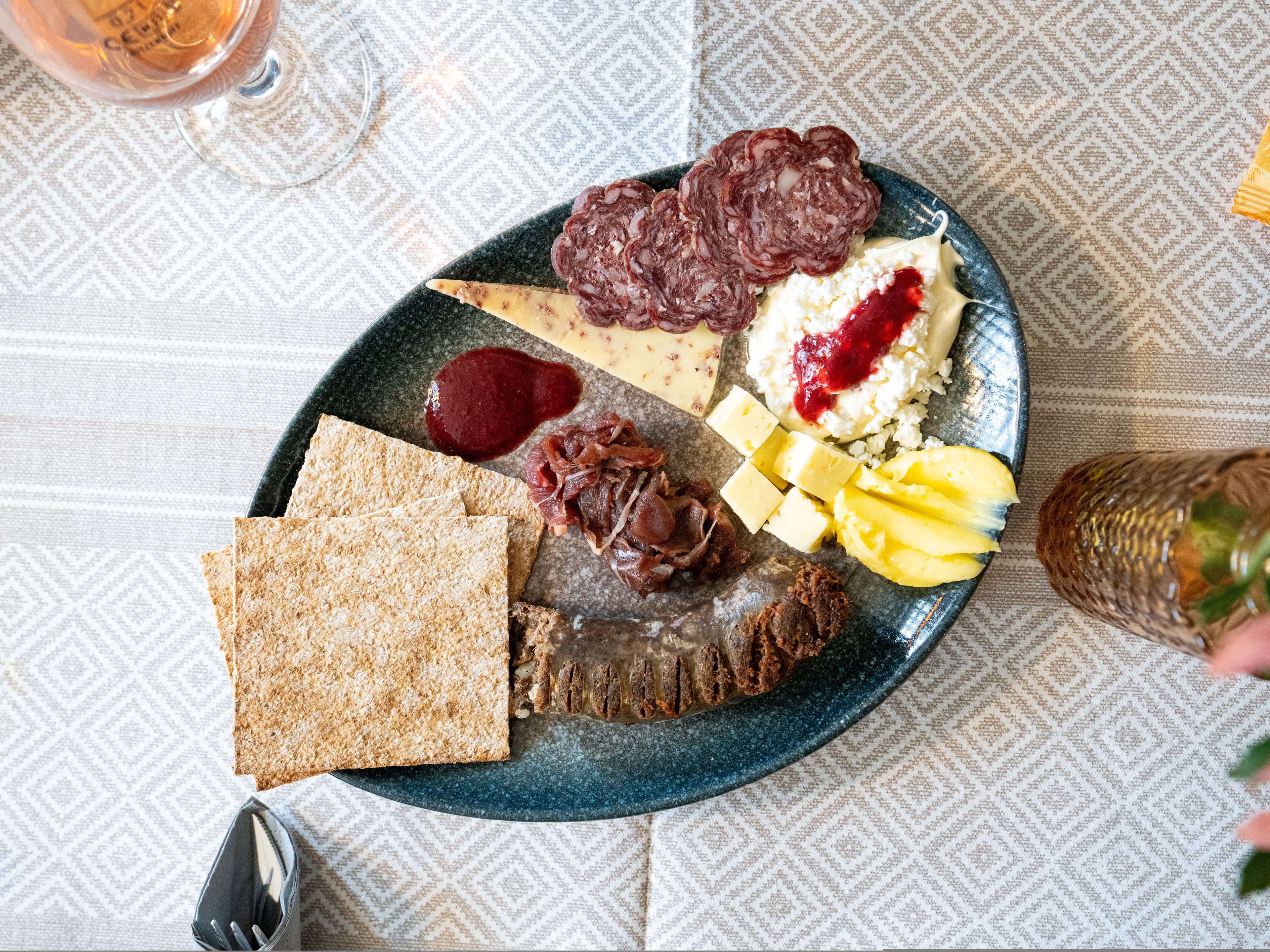 A plate full of dried meats and cheeses
