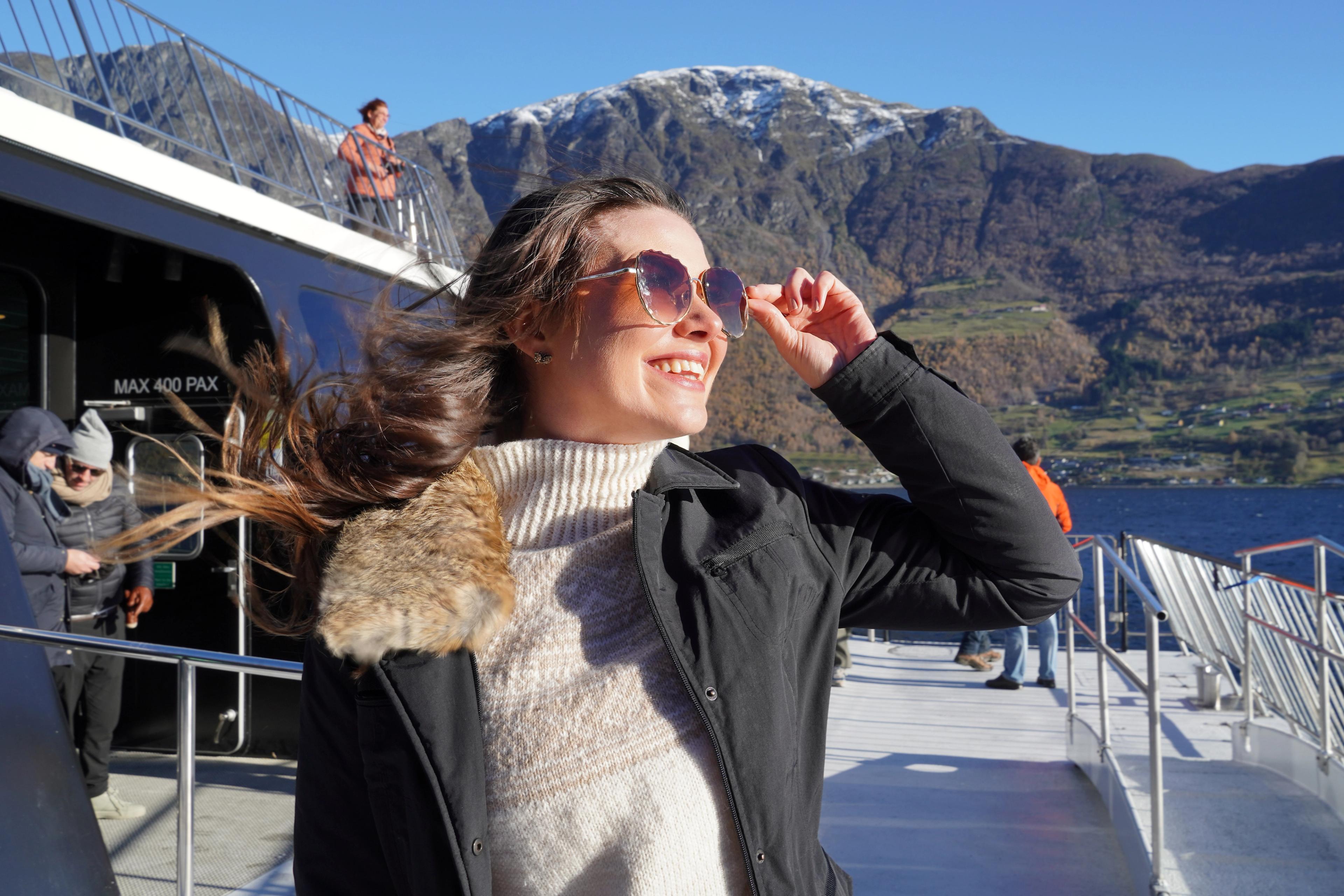 Woman with sunglasses on a fjord cruise.