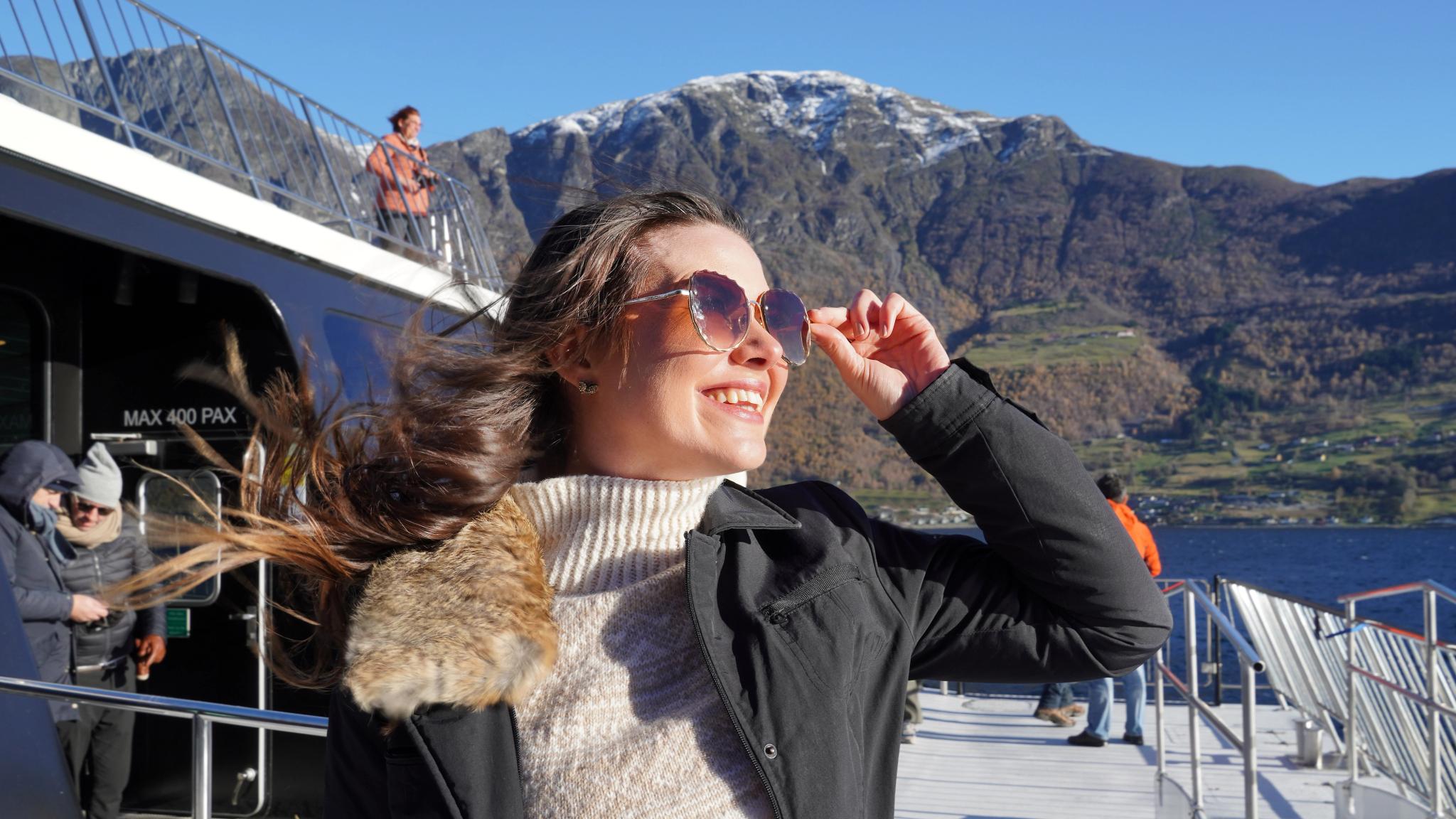 Woman with sunglasses on a fjord cruise.