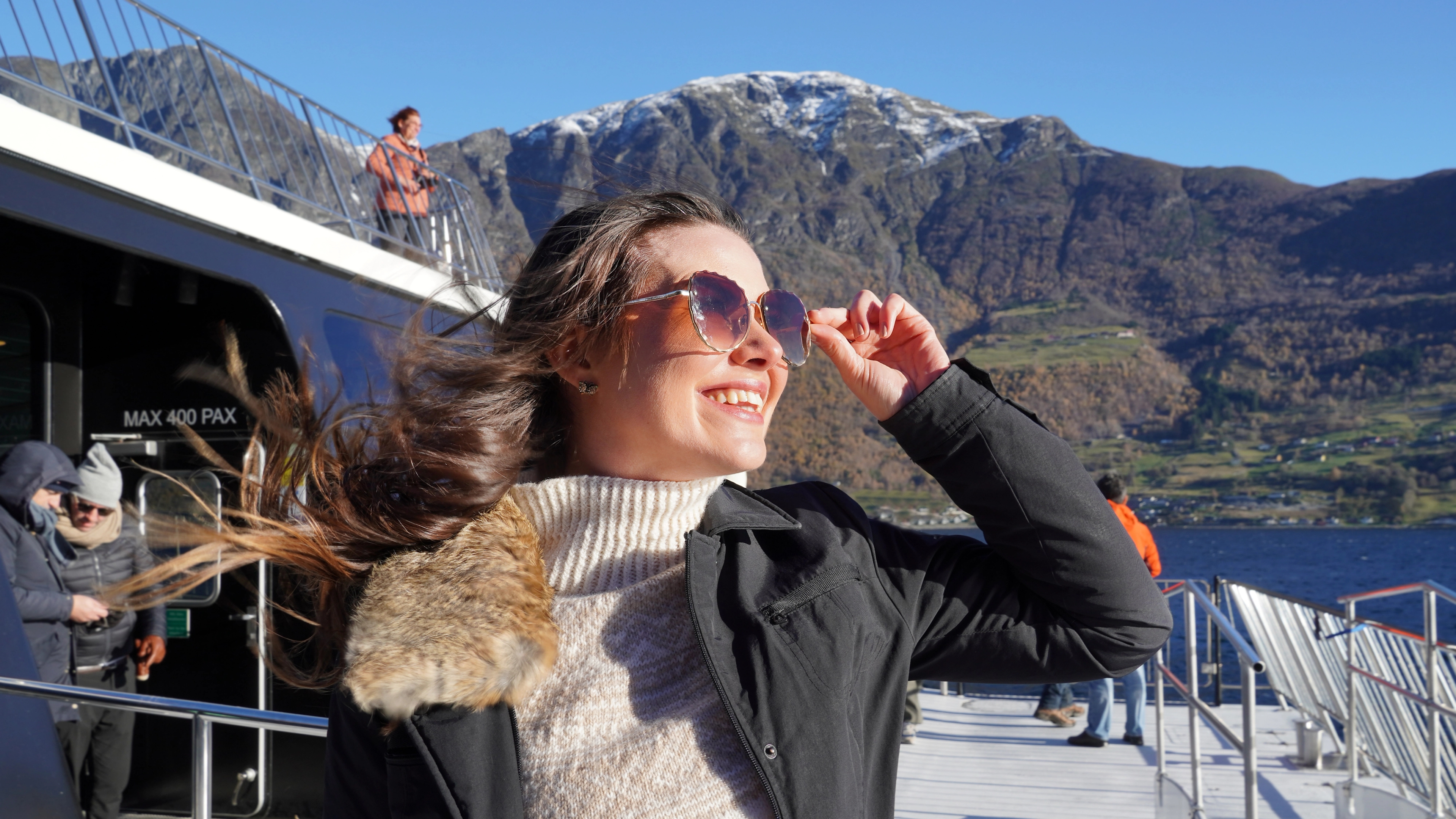 Woman with sunglasses on a fjord cruise.