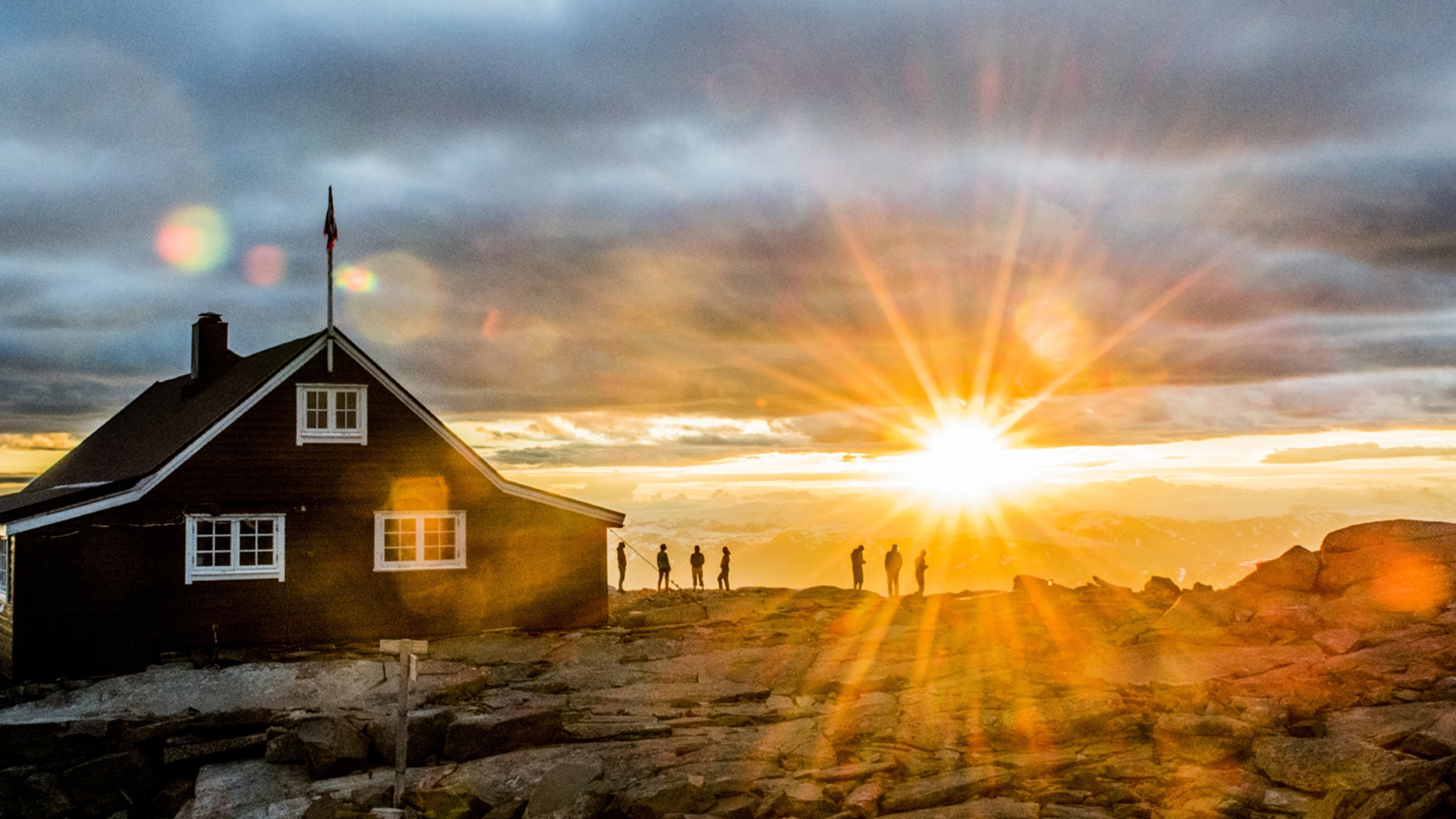 People watching the sunset at the Fannaråken cabin in Jotunheimen, Norway