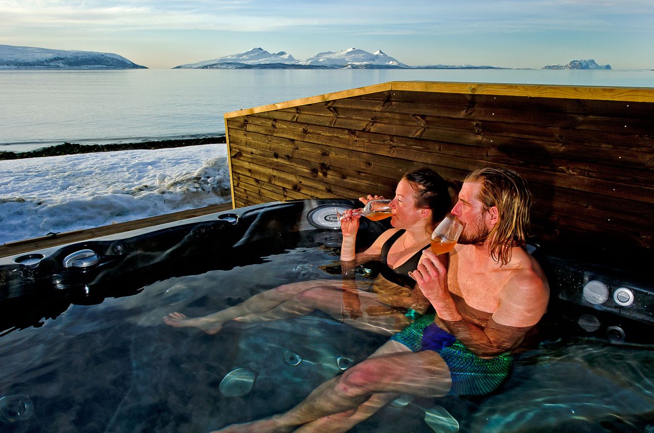 Two people sitting in a hot tub