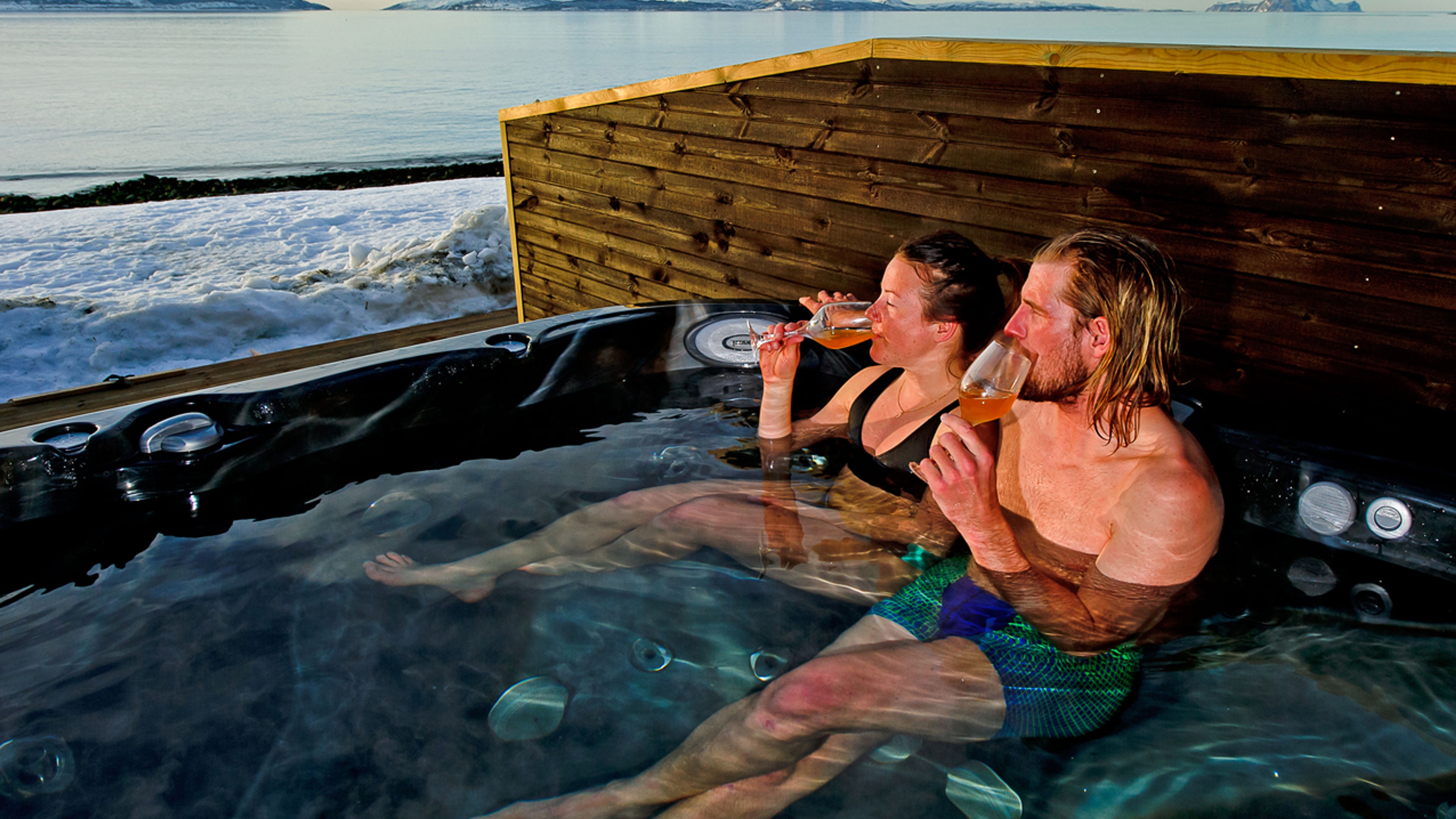 Two people sitting in a hot tub